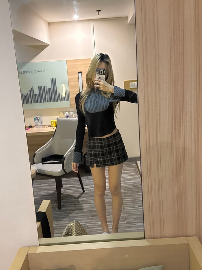 Woman takes mirror selfies in Chongqing hotel room