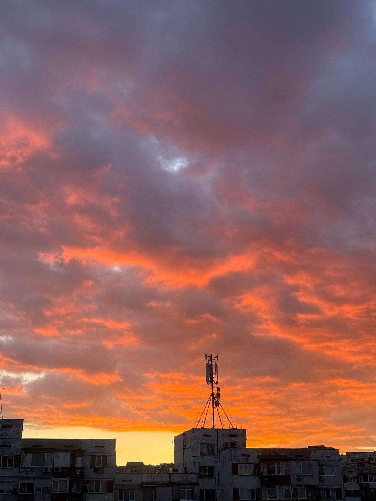 Dramatic sunset illuminates Sofia skyline amid storm clouds