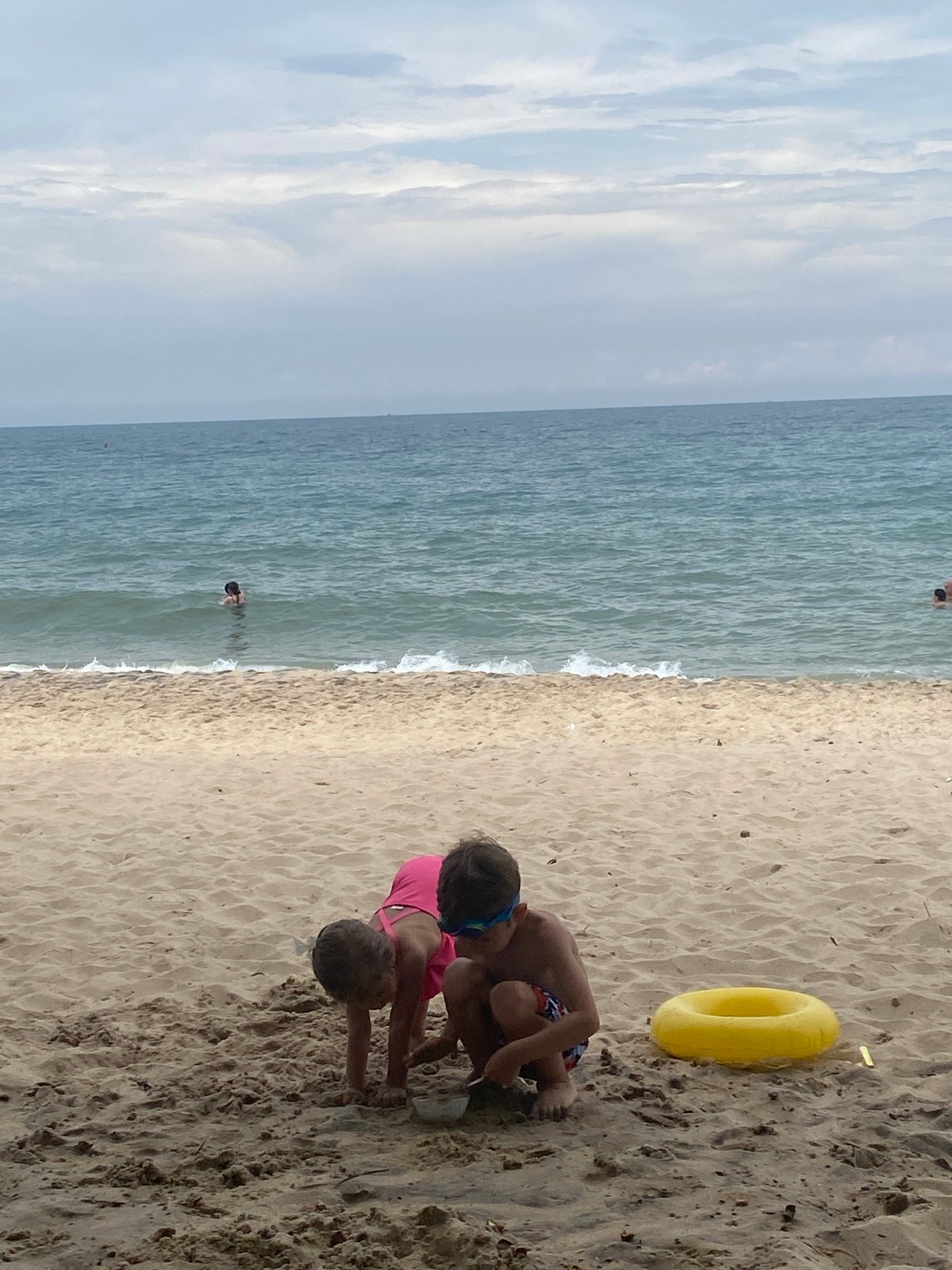 Beach day at a Vietnamese resort, kids playing, adults relaxing