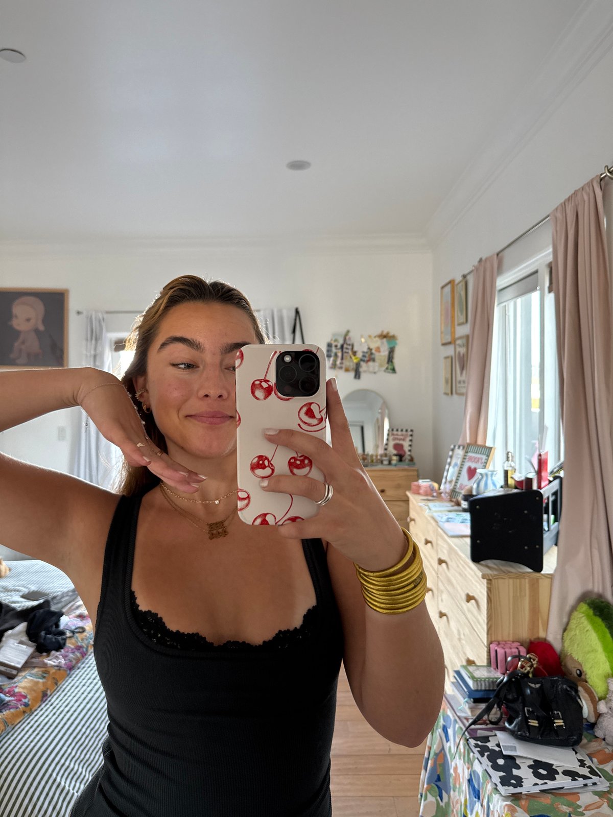 Woman takes mirror selfies with dachshund in LA bedroom