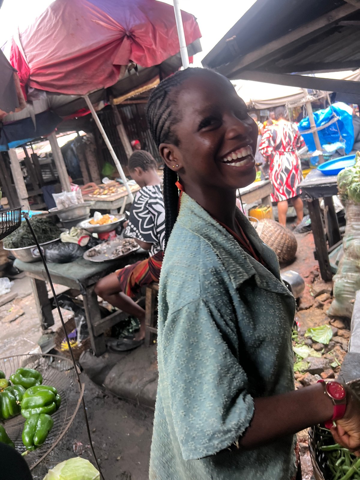 Smiling face at a bustling outdoor market in Nkpor, Nigeria