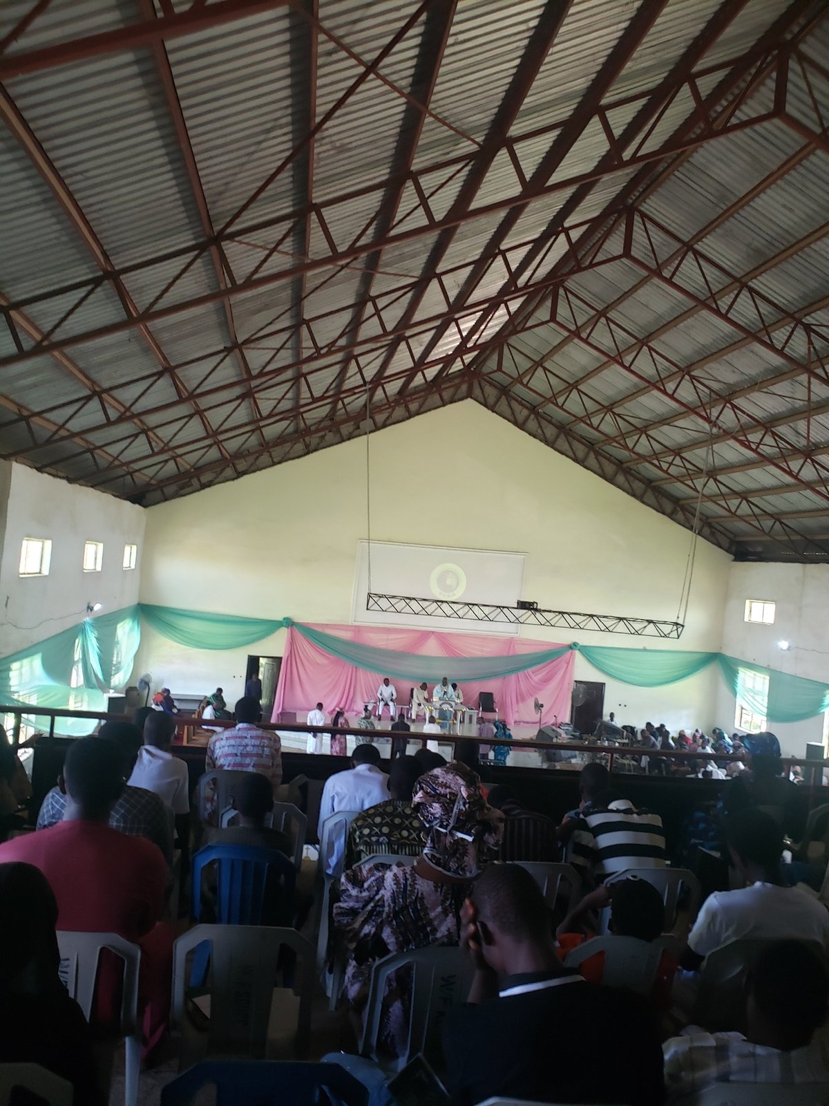 Witness documents indoor gathering and concrete building in Narayi
