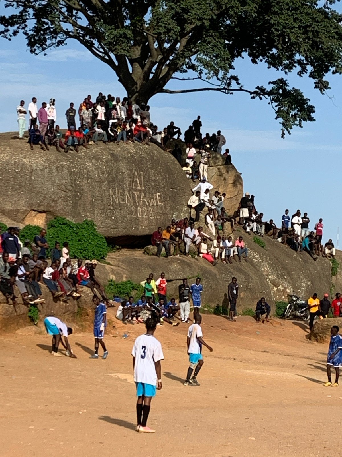 Pickup soccer on a rocky dirt field in Jos, Nigeria