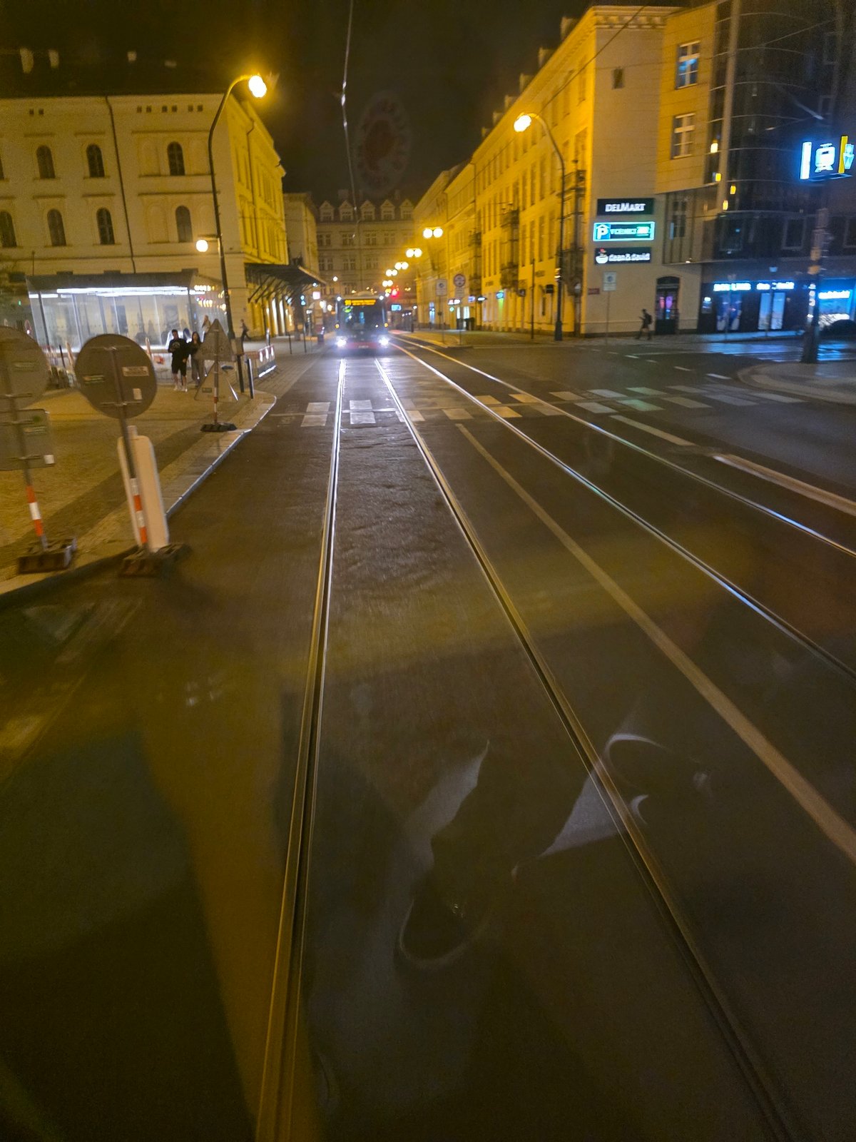 Nighttime tram journey through illuminated city streets documented