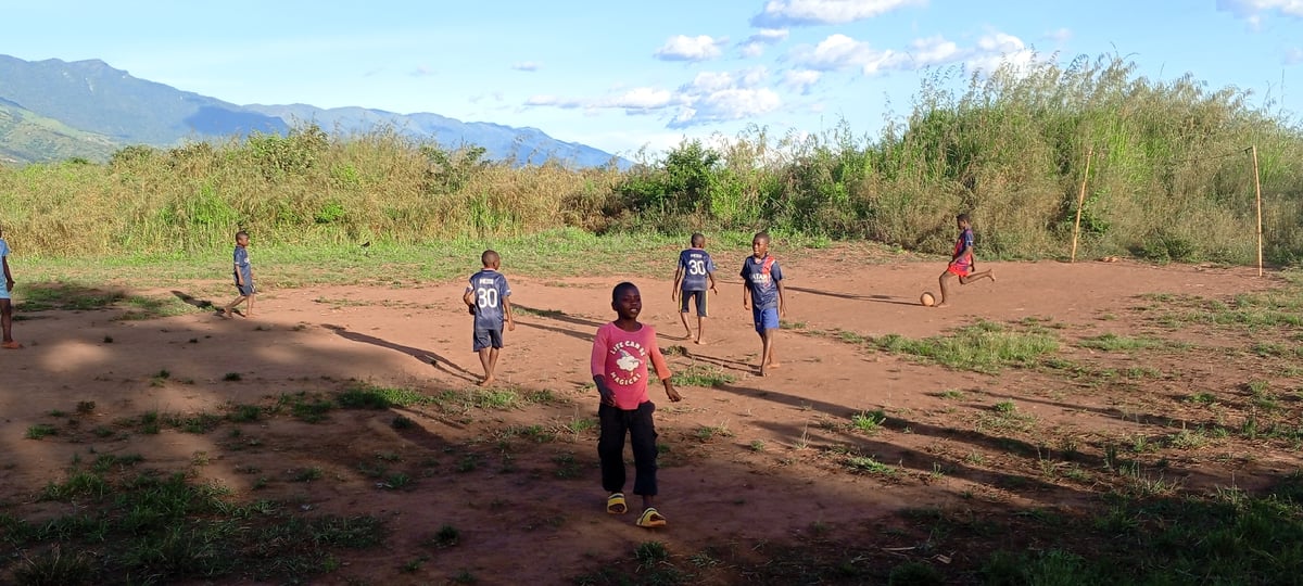 Children play informal soccer match in rural Ngalula, DRC