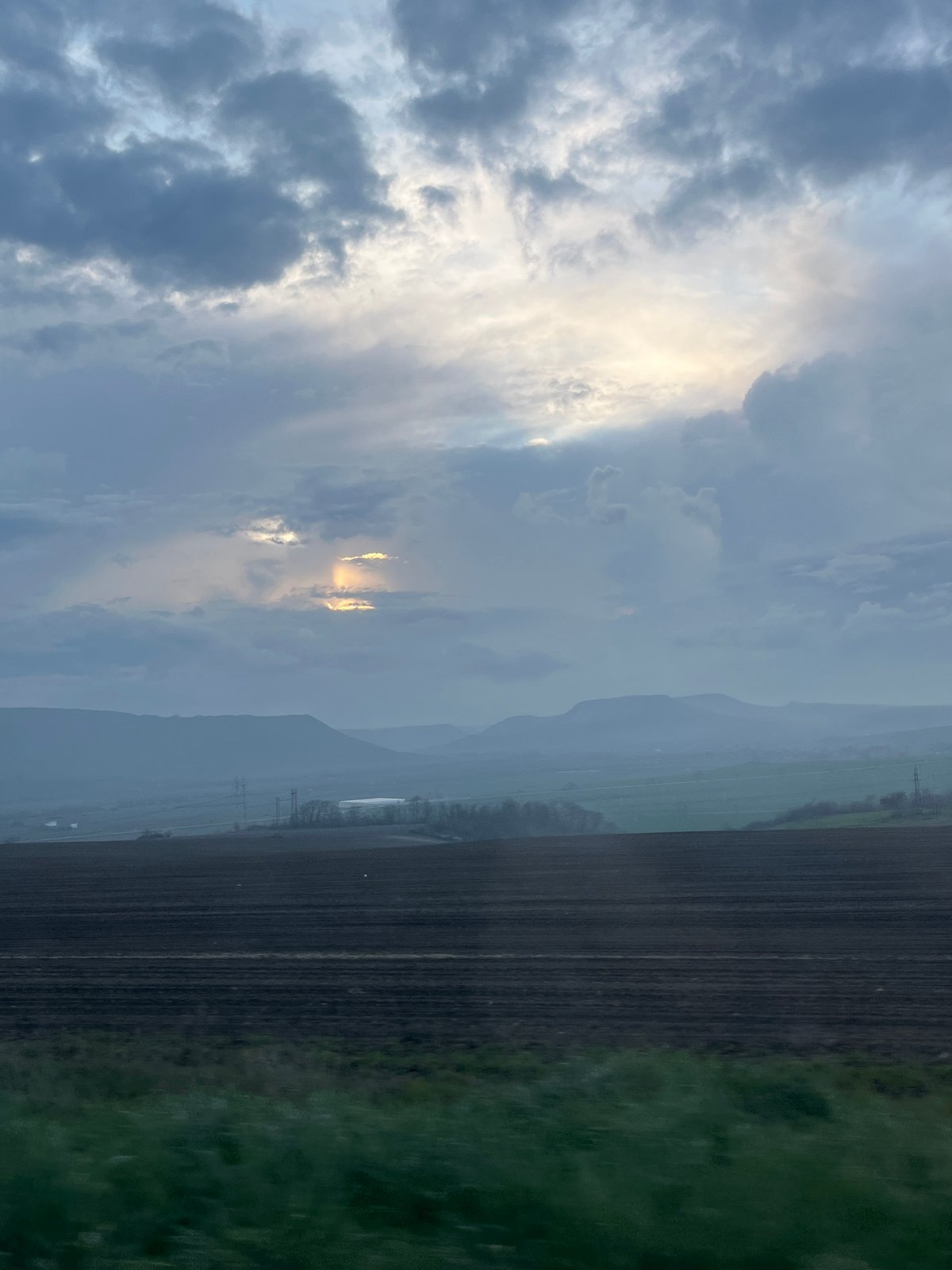 Sunlight breaks through clouds over Petrov Dol landscape