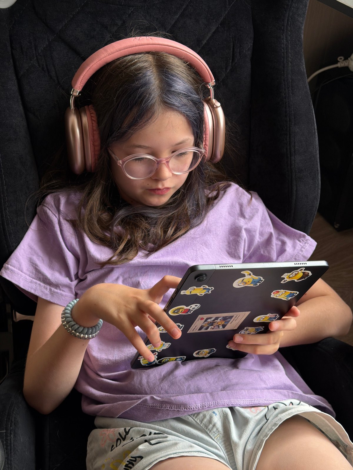 Girl with tablet, Chihuahua play among stuffed animals in Russia