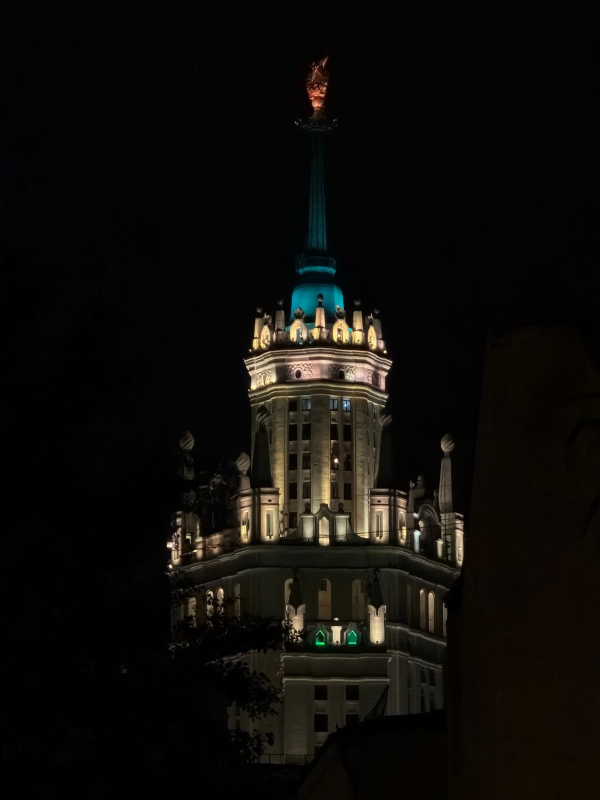 Illuminated spired building observed in Moscow at night