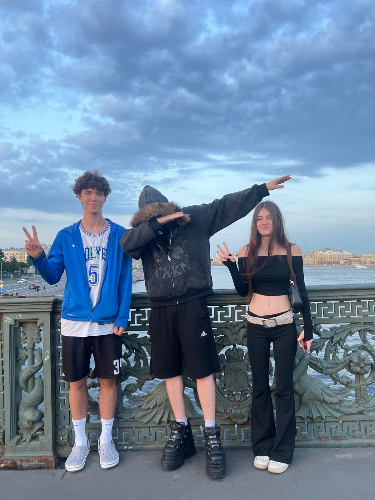 Young people gather on city bridge during evening hours