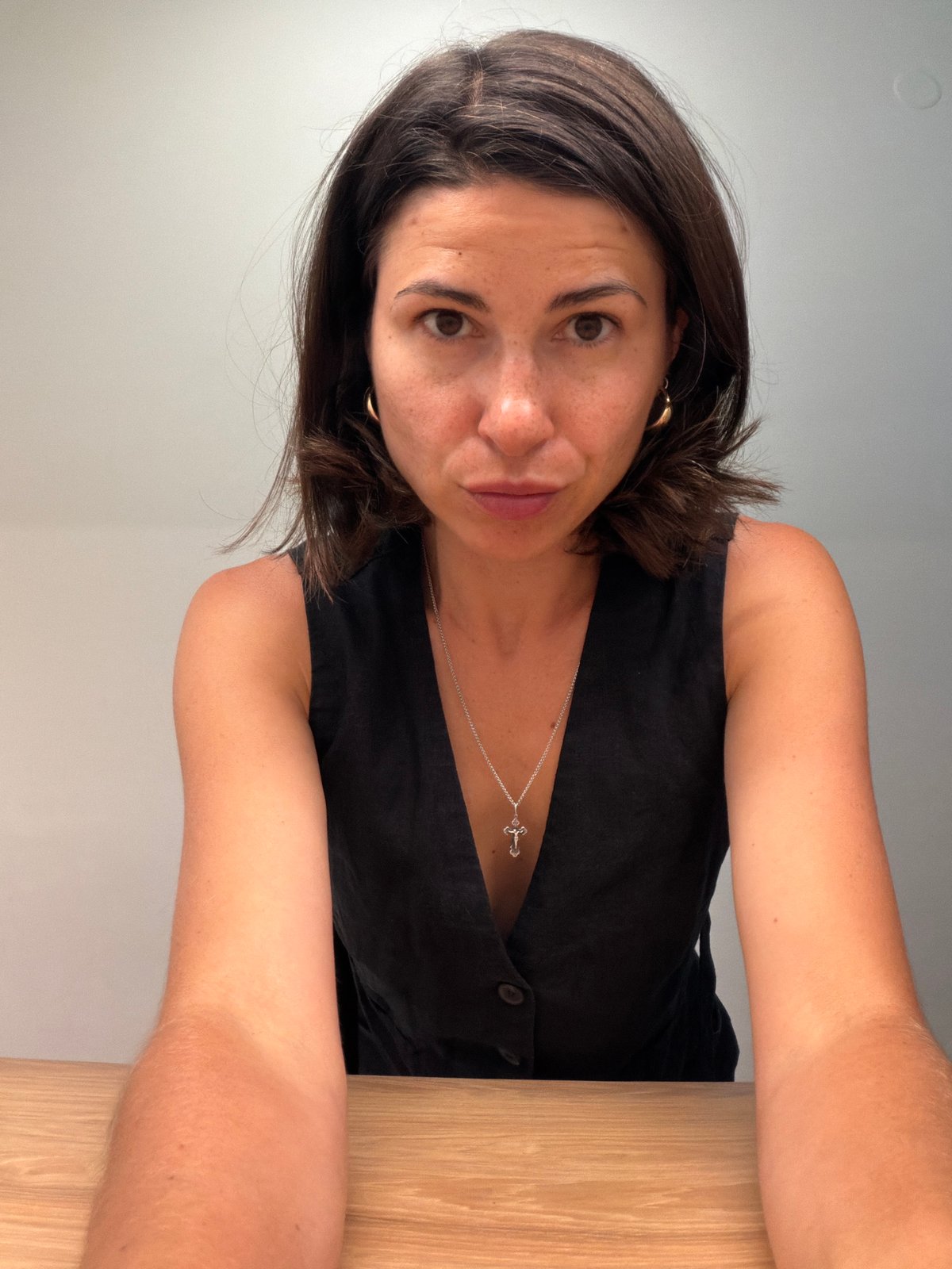 Woman takes multiple selfies indoors in Budva, Montenegro