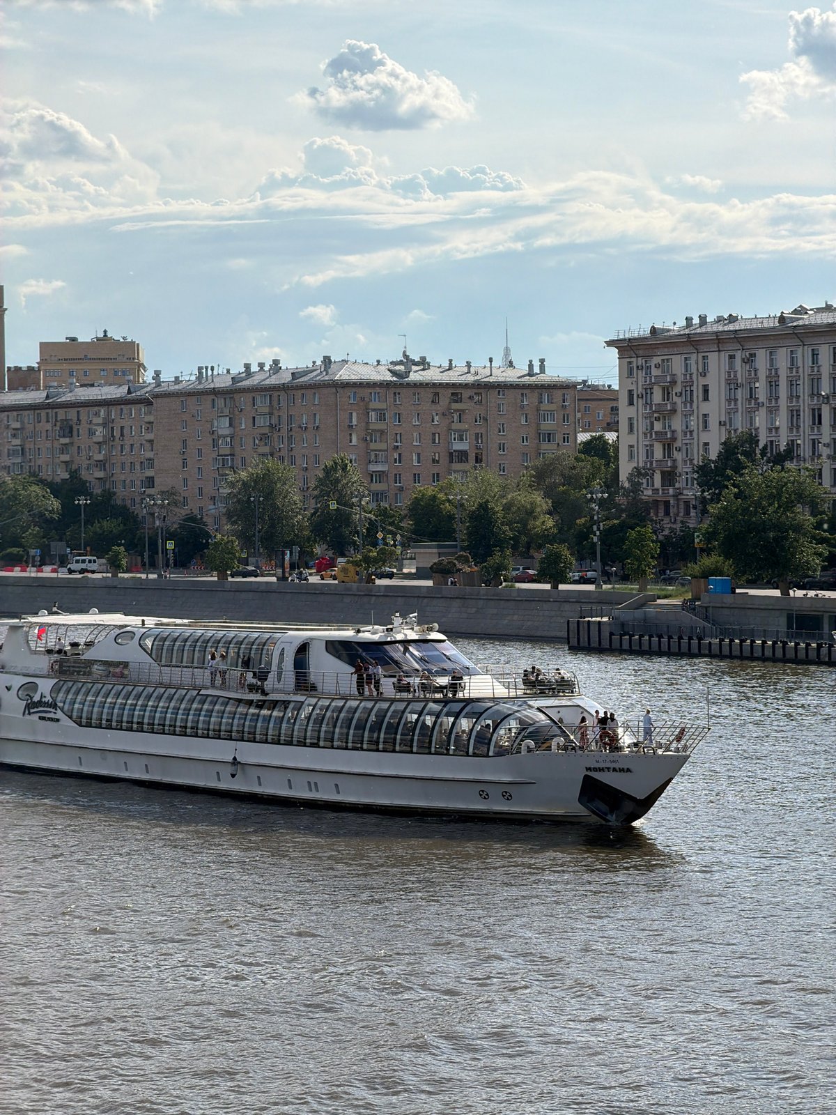 Passenger boats cruise Moscow River near Peter Great monument
