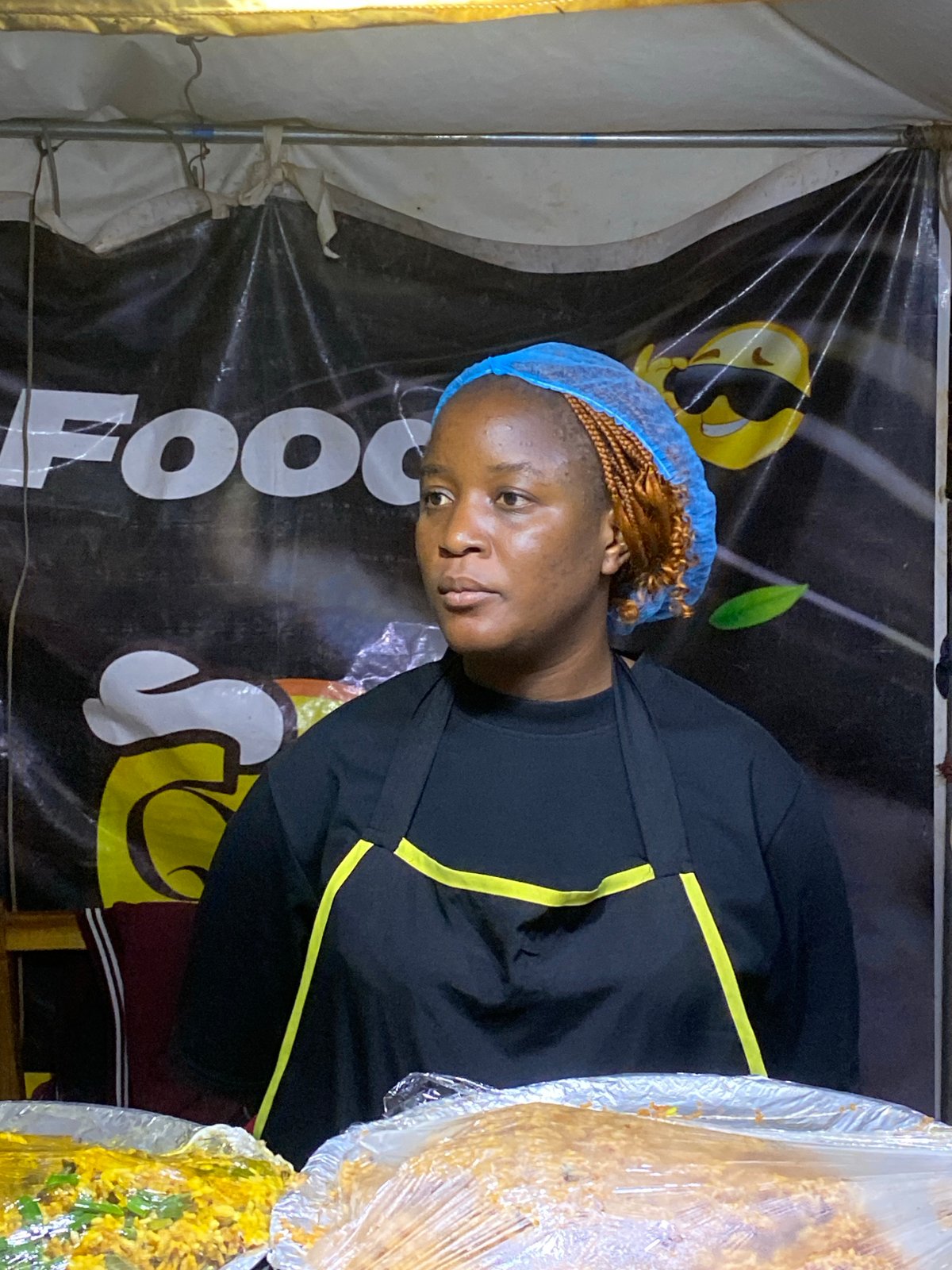Night food stall and campaign banners in Gwong, Nigeria