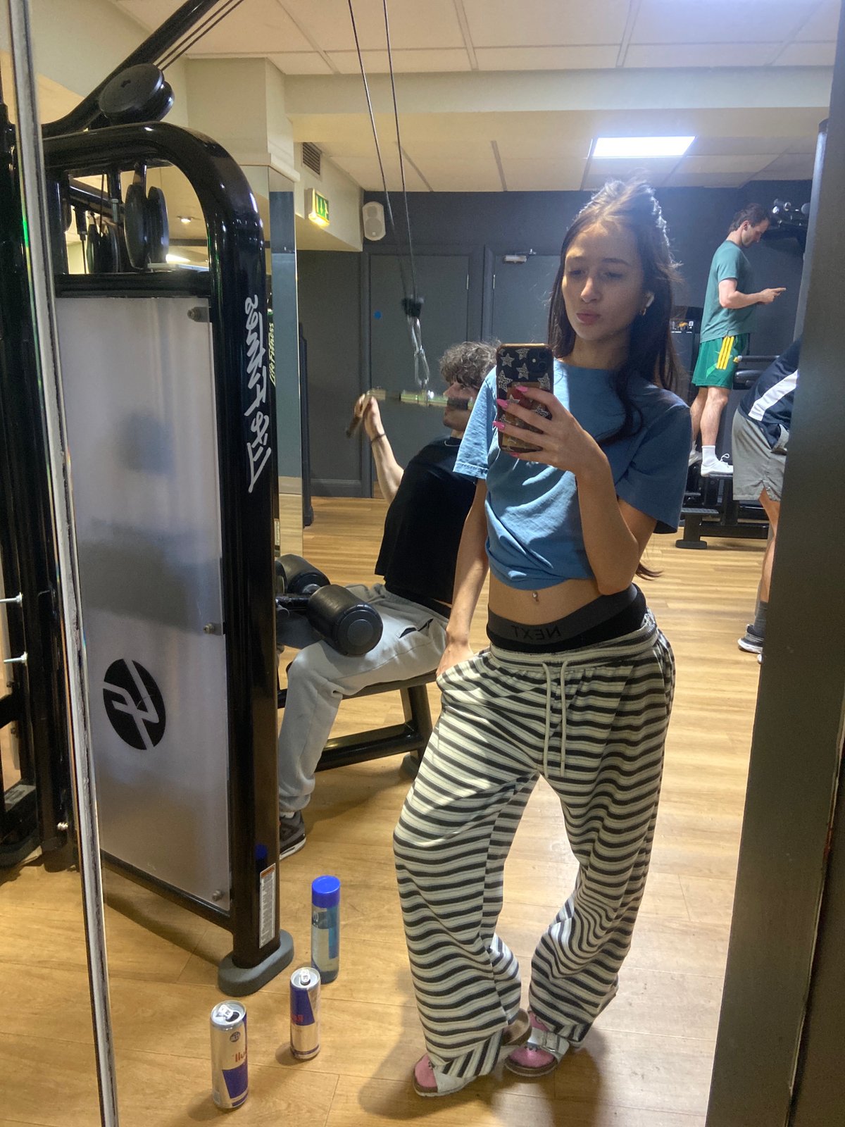 Woman takes gym selfie in casual pajama outfit