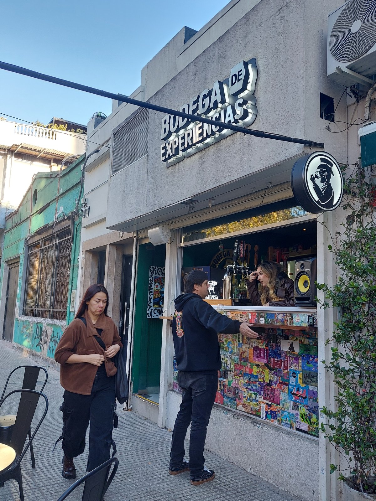 Evening street activity documented at Buenos Aires storefronts
