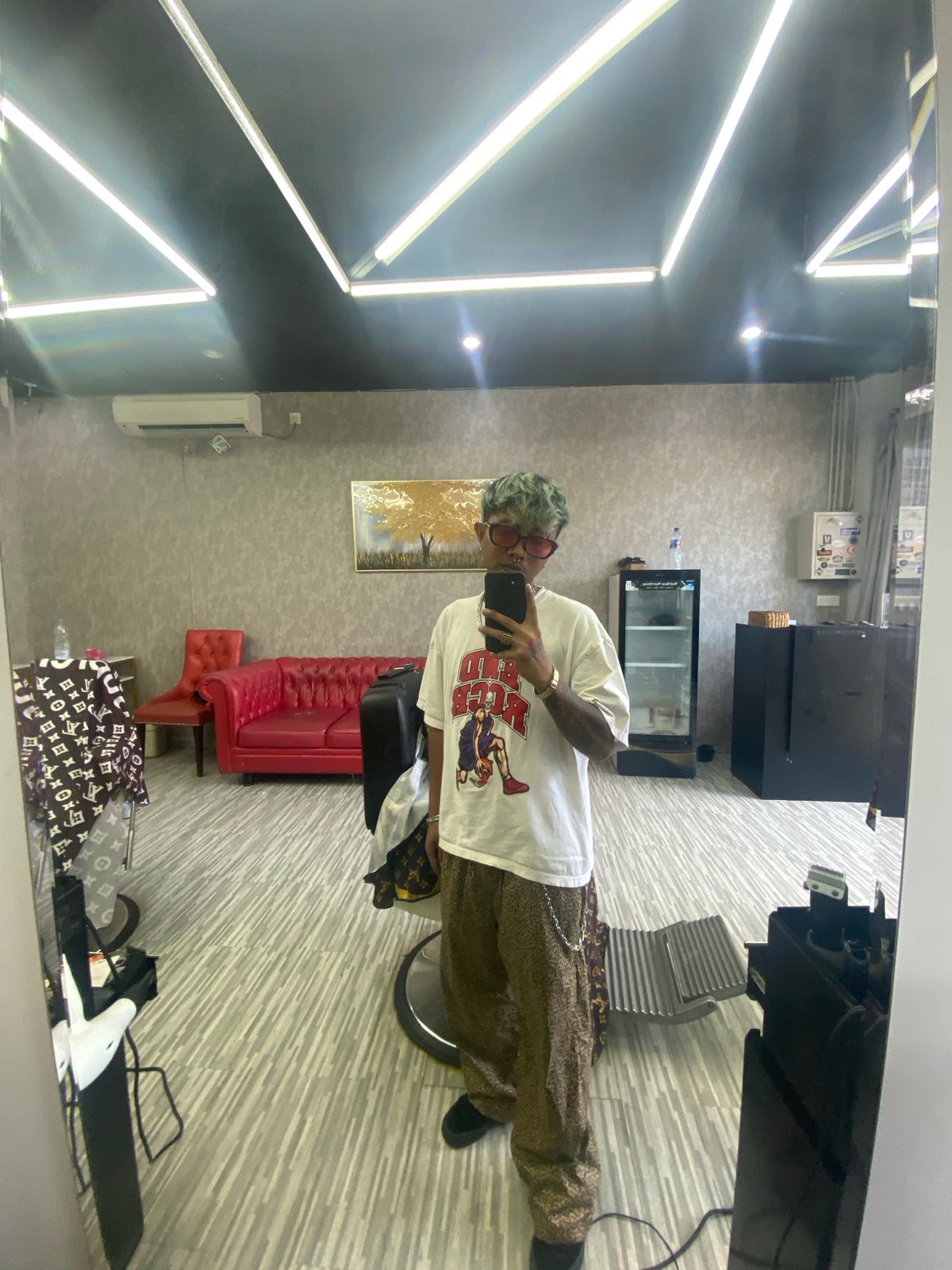 Green-haired person takes salon selfie in Kuta, Indonesia