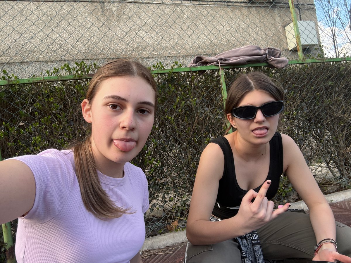 Young women play, dance, take selfies in Bulgarian courtyard