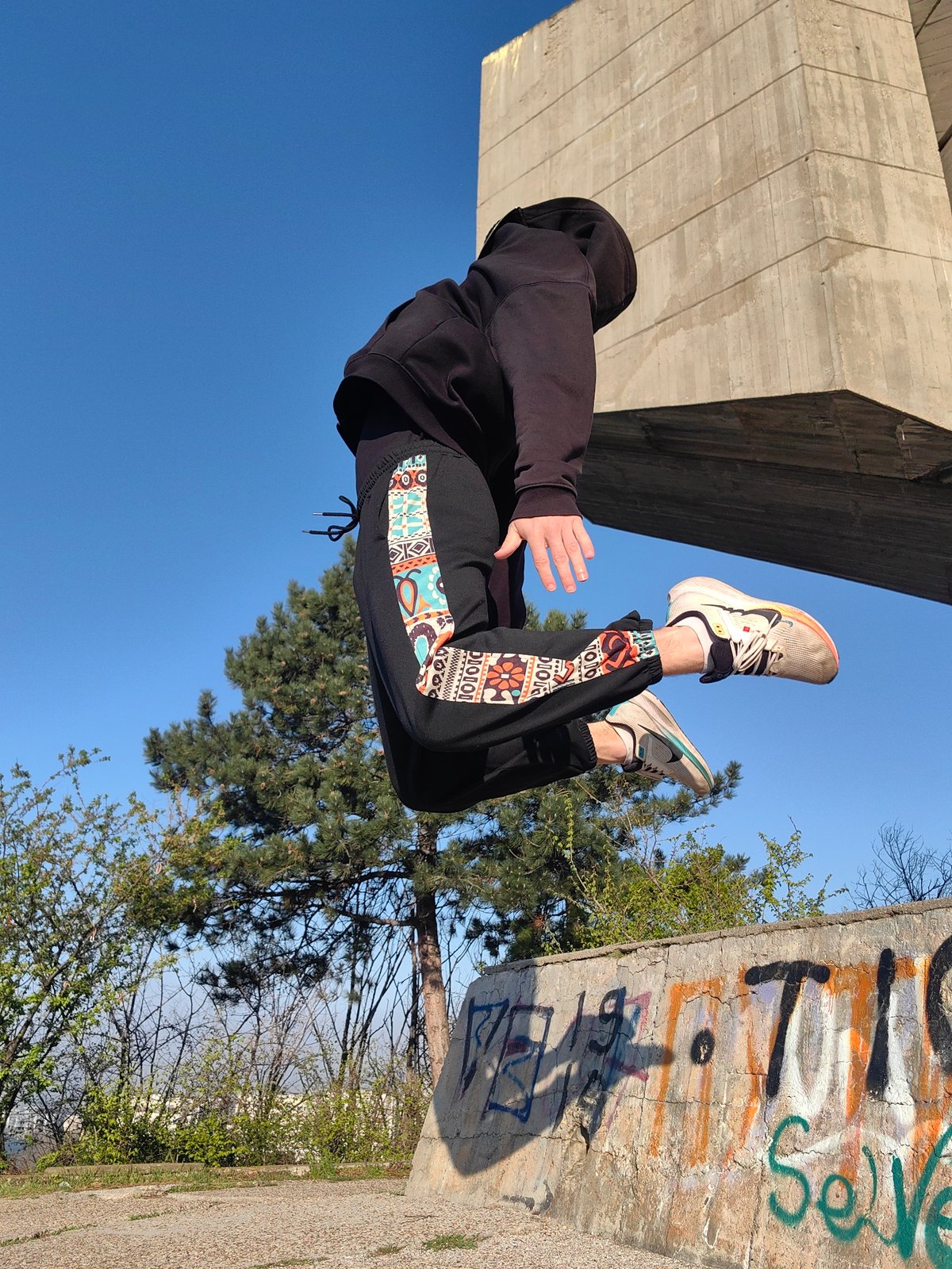 Person performs athletic stunts near Bulgarian monument in Varna