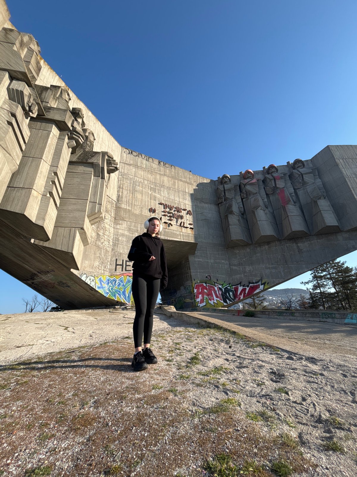 Person performs morning yoga on urban concrete monument