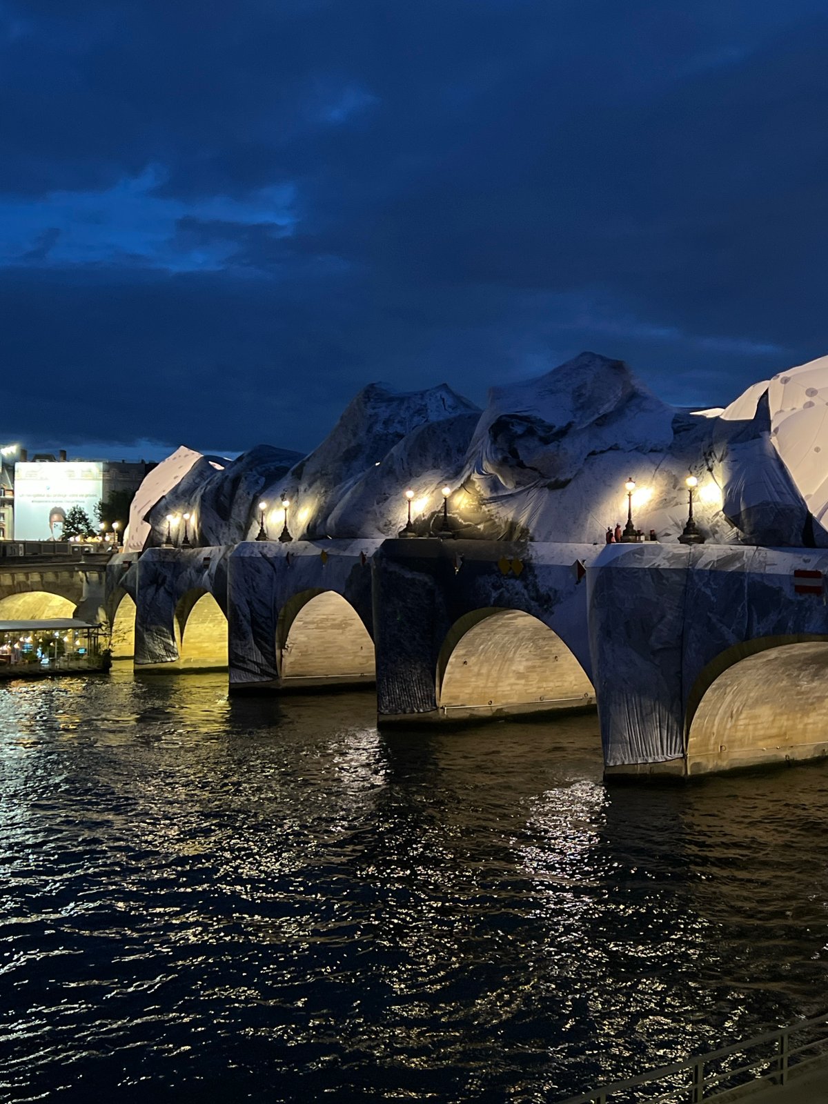 White fabric art installation transforms Paris bridge into alpine landscape