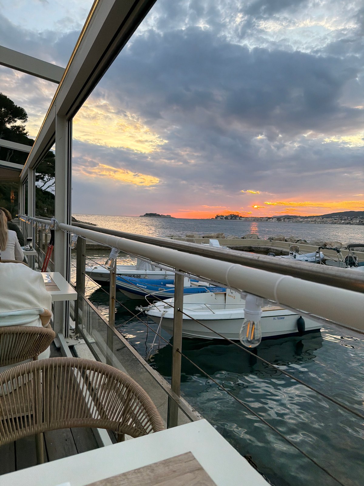 Sunset observed over Sanary-sur-Mer marina from waterfront location