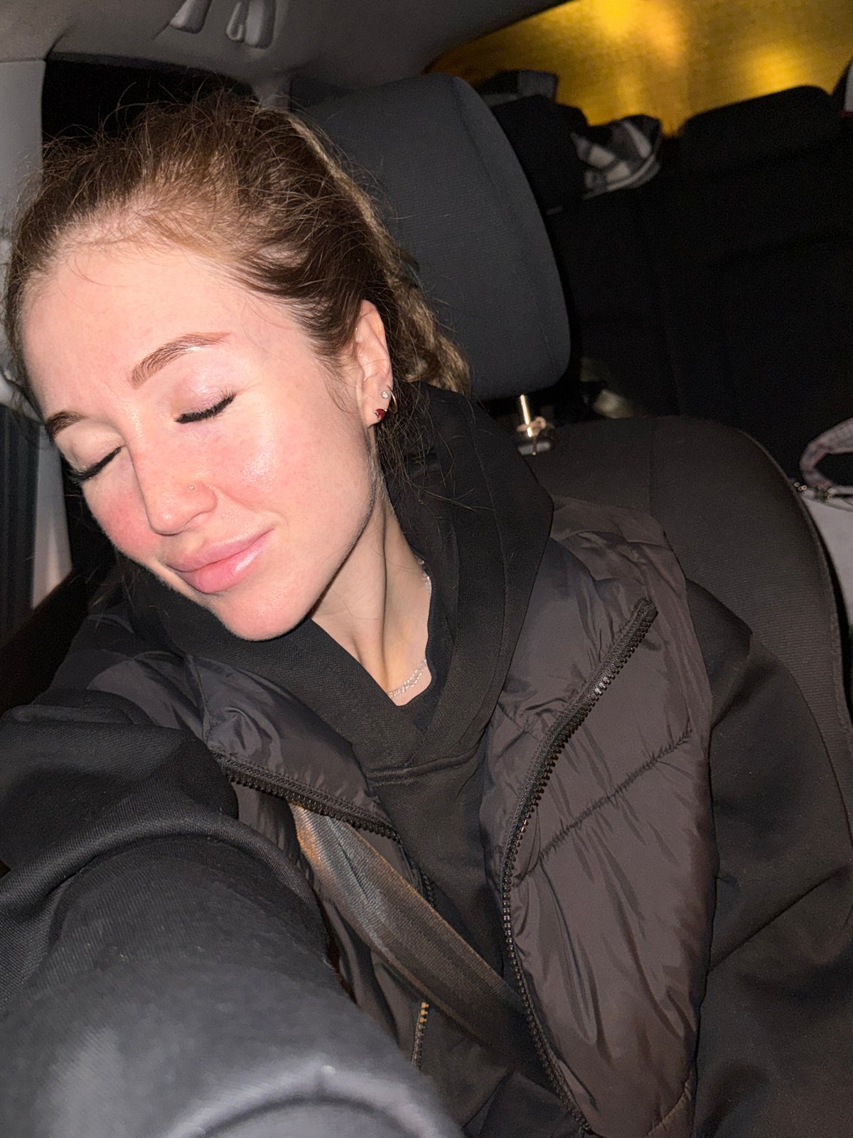Woman sleeps in car backseat in Kryukovo, Russia