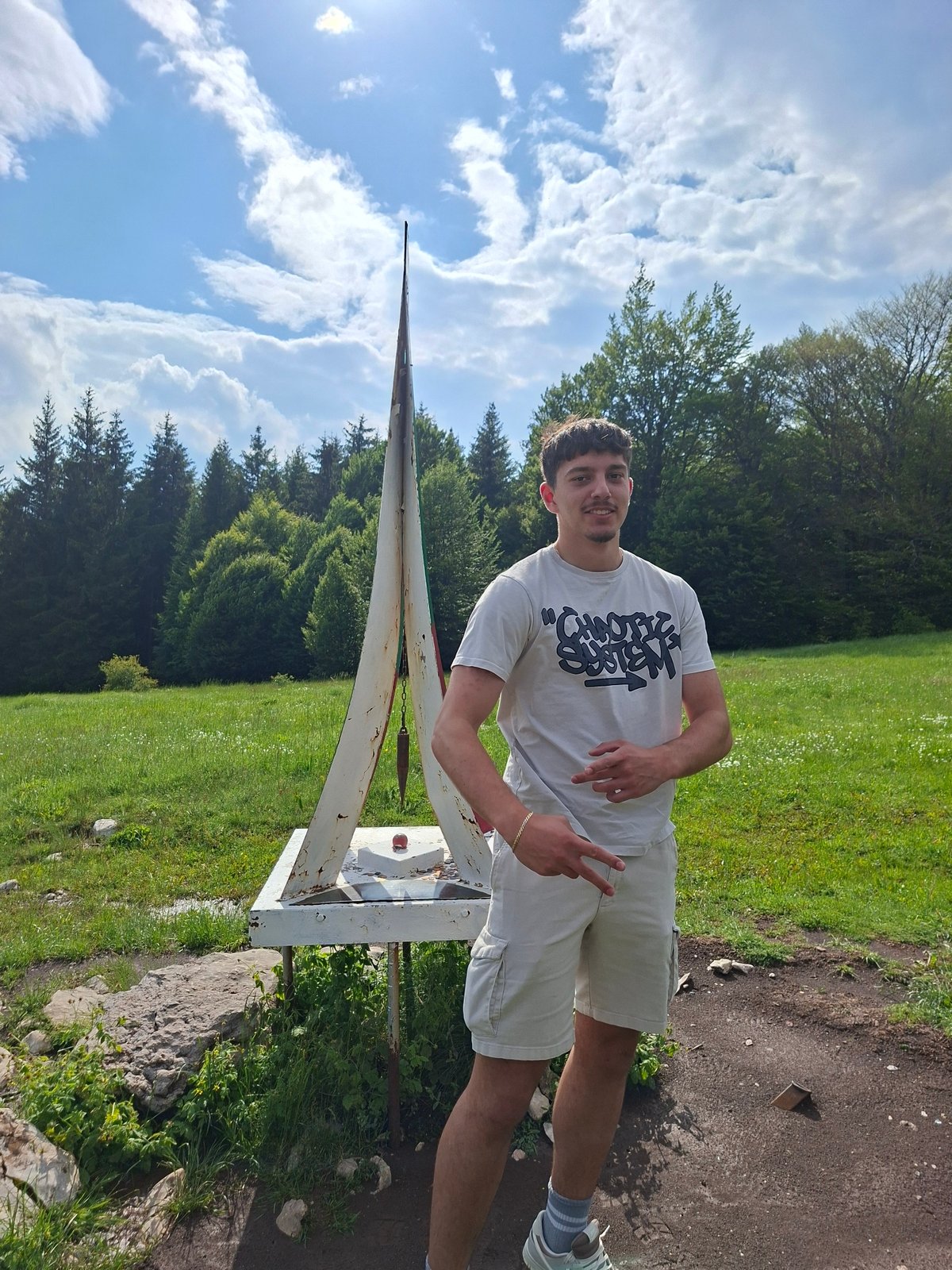 Man photographed near geodetic monument in Gabrovo countryside
