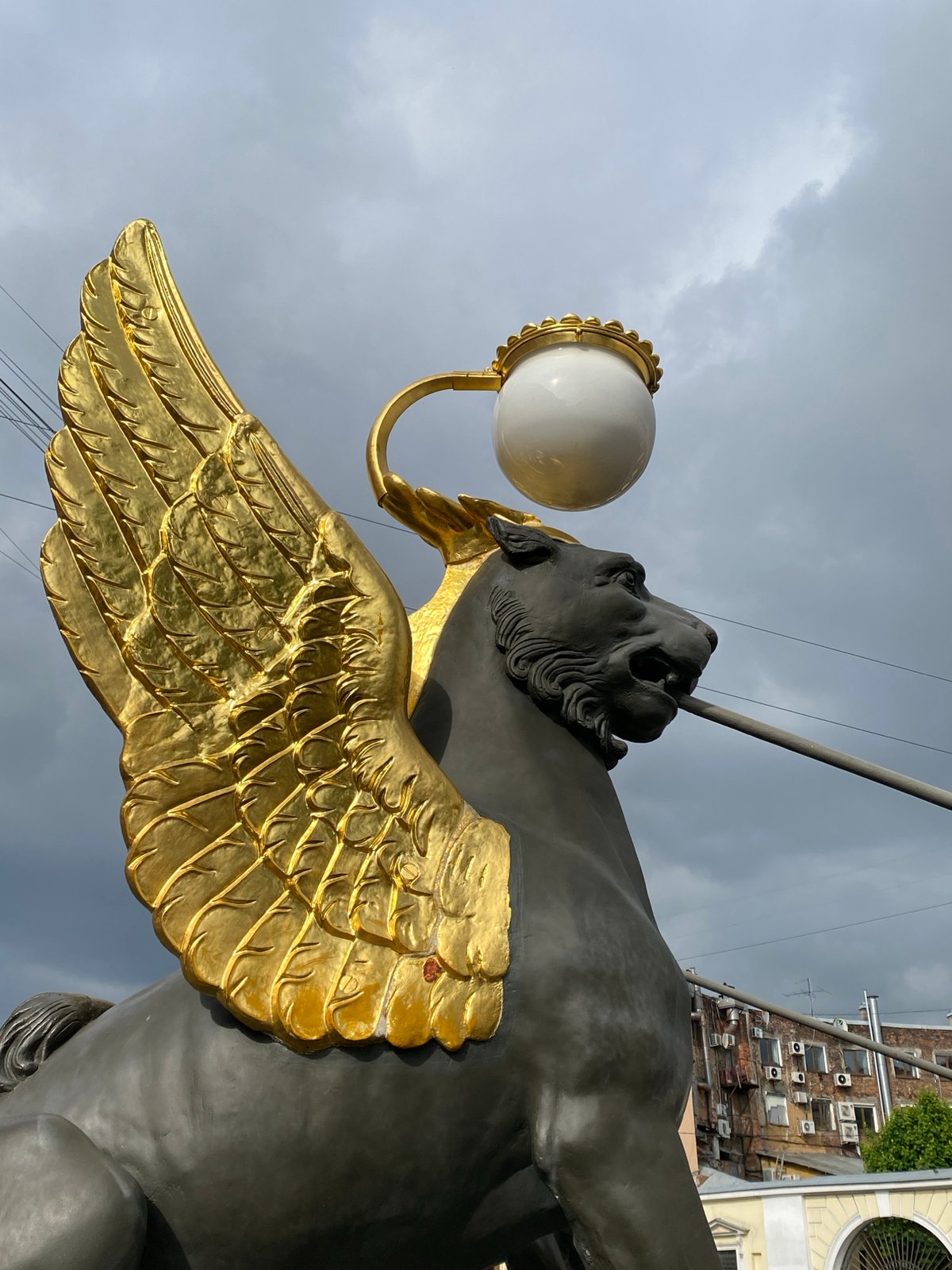 Tourist documents Saint Petersburg's Bank Bridge griffin statues and architecture