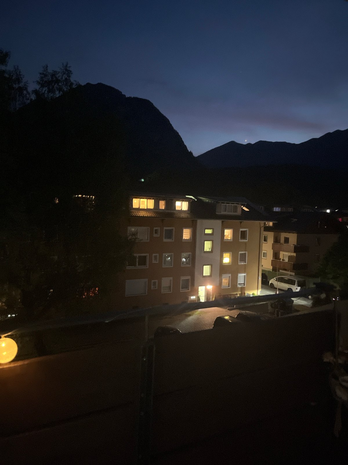 Balcony twilight in Garmisch, string lights and alpine dusk