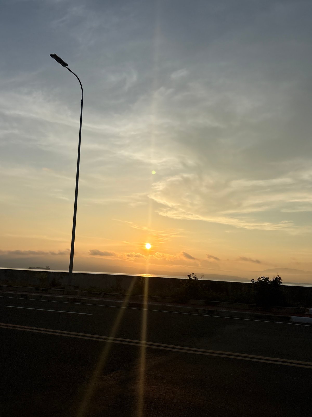 Motorcycle rider captures sunset journey through Davao City coastal roads