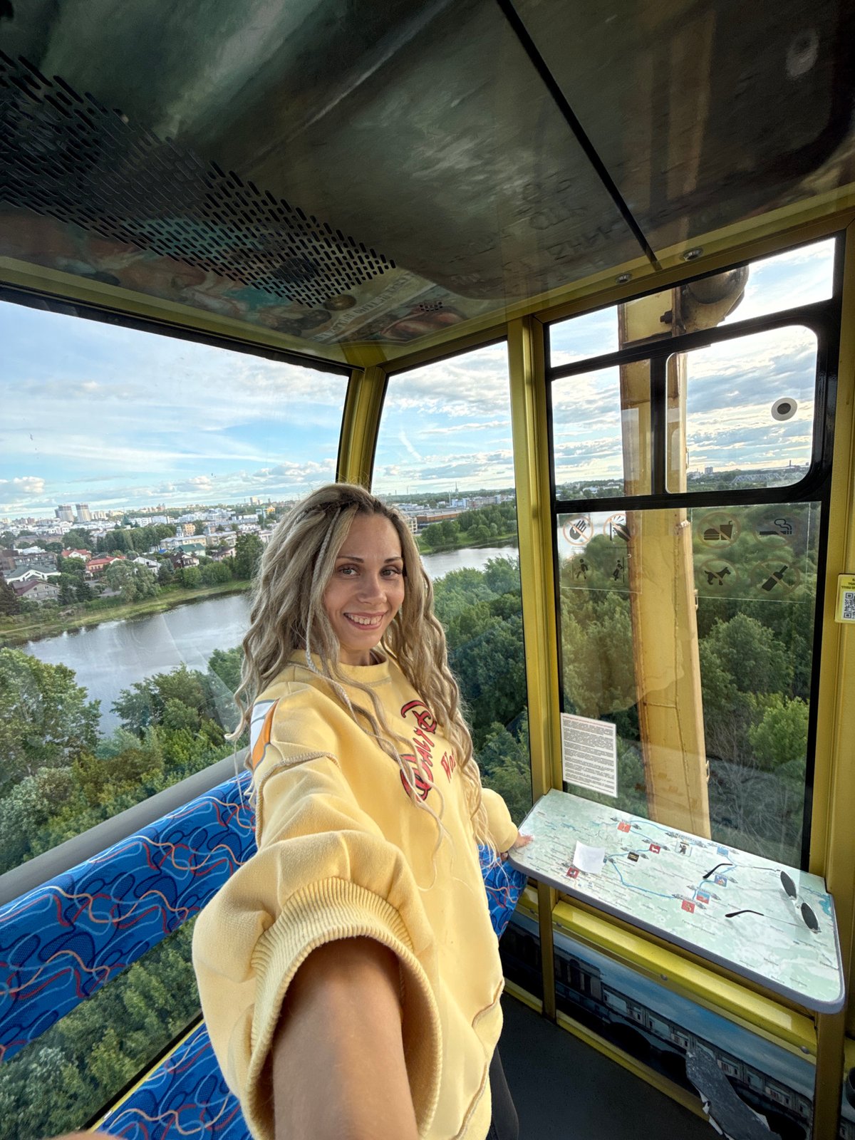 Woman rides cable car with city views in Шебунино