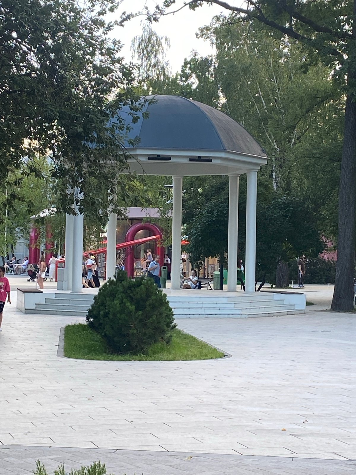 Summer evening at a busy Moscow park, circus nearby