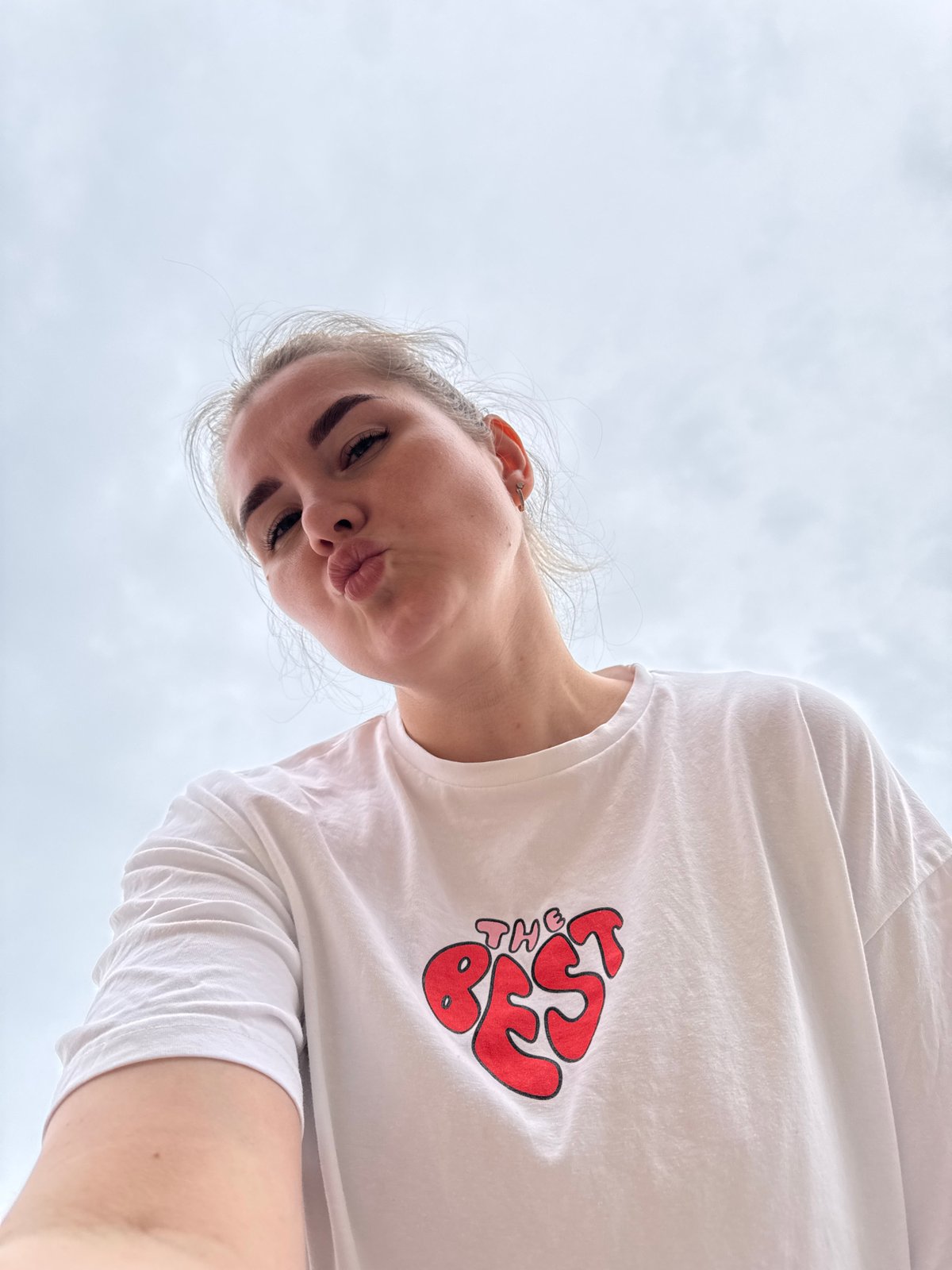 Woman takes selfie on cloudy street in Горный, Russia