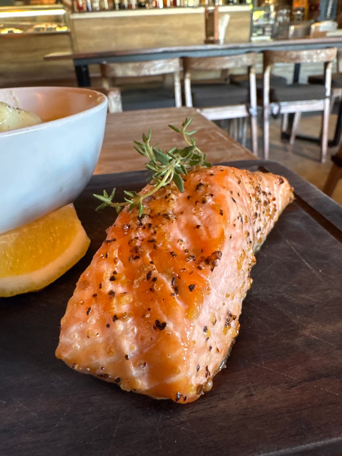 Diner documents salmon meal at Kuta restaurant