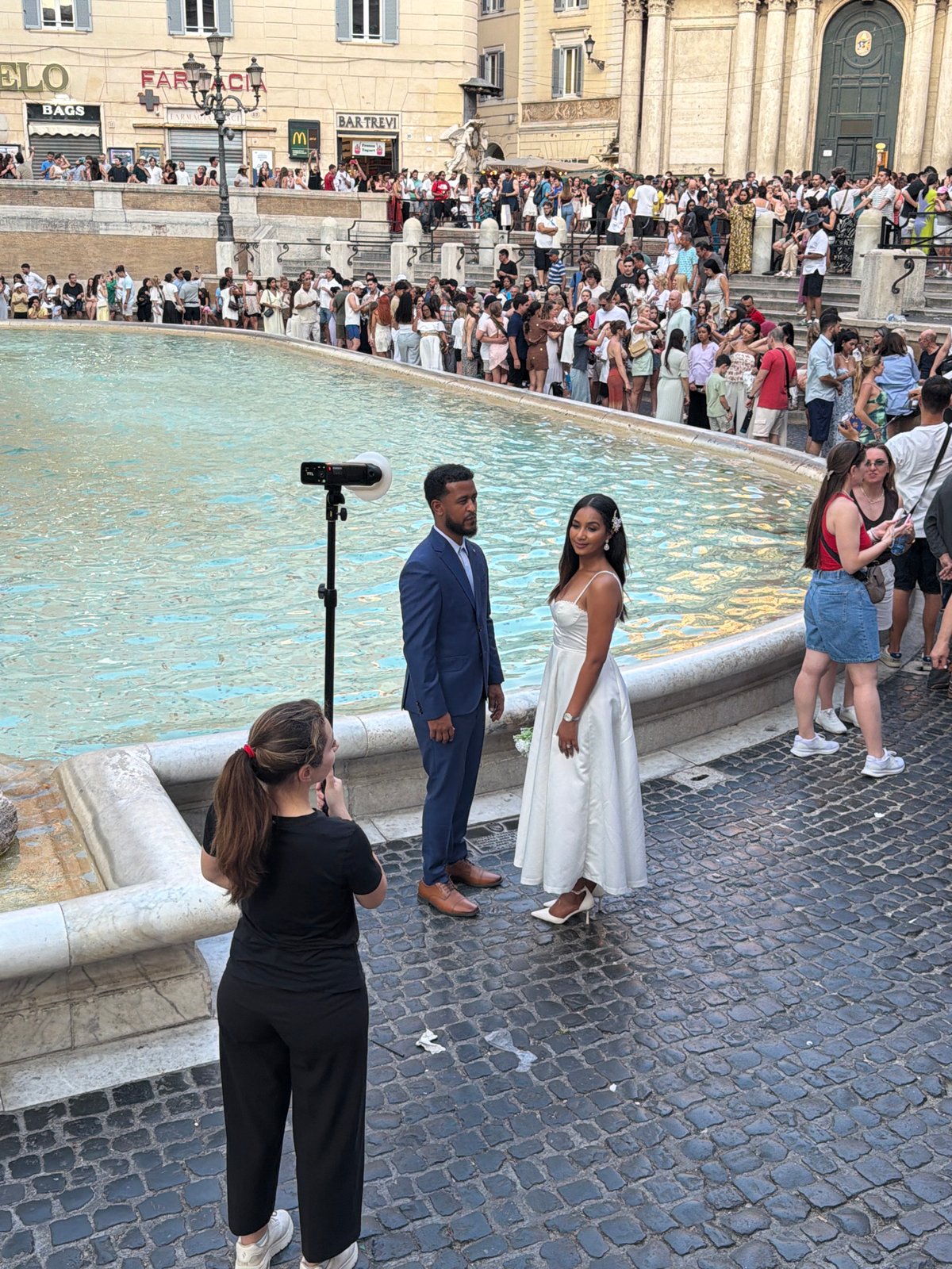 Crowds and couples at Rome's Trevi Fountain