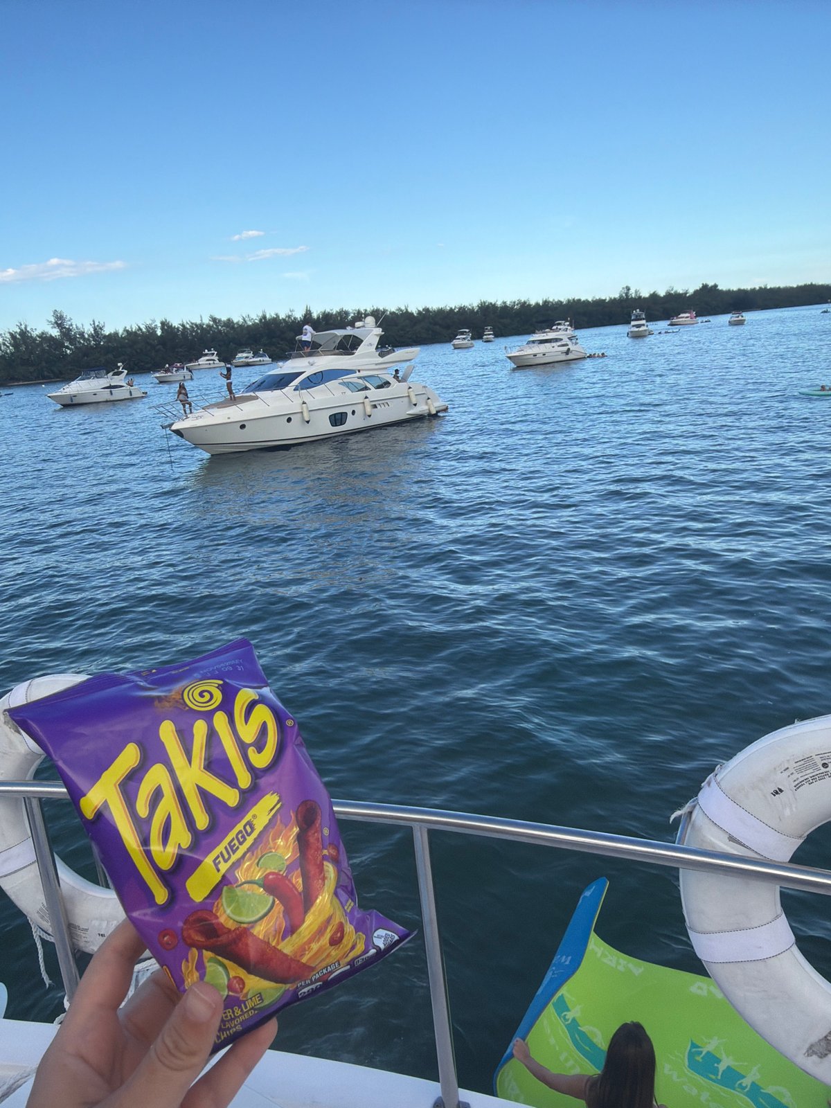 Miami boat day with Takis, drinks, and skyline views