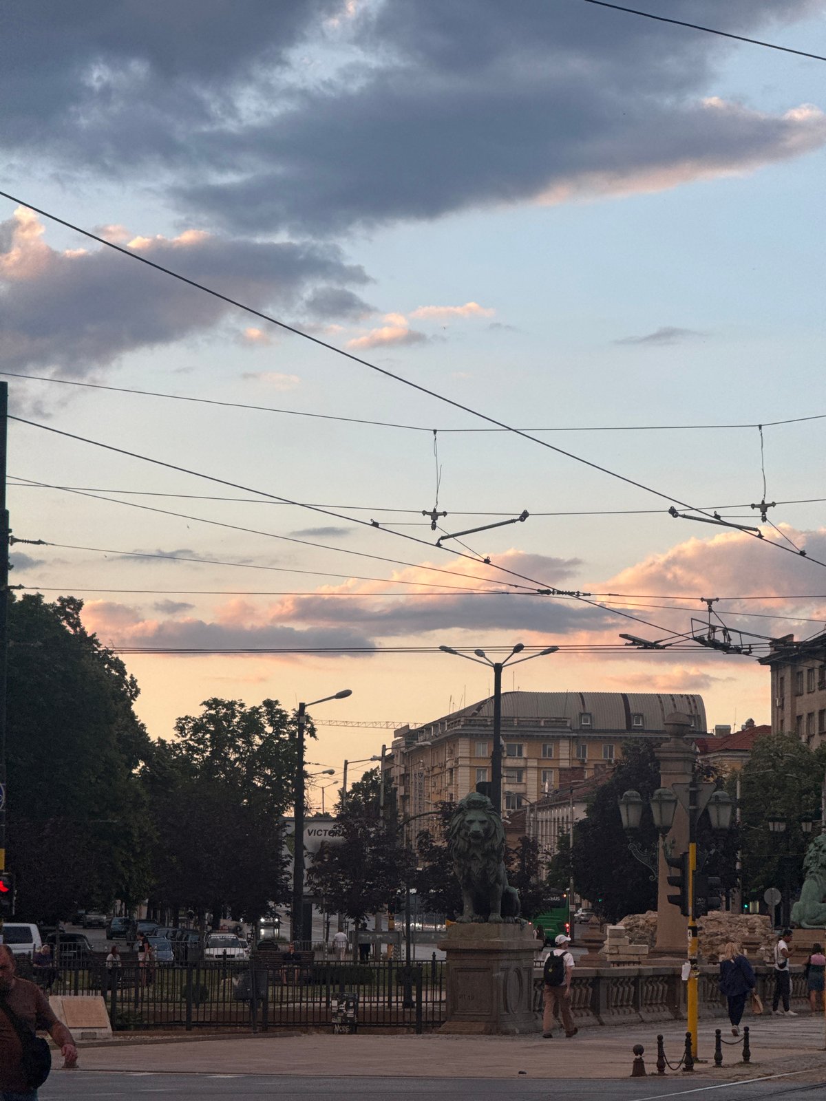 Evening streets of central Sofia, trams, clouds, and city life