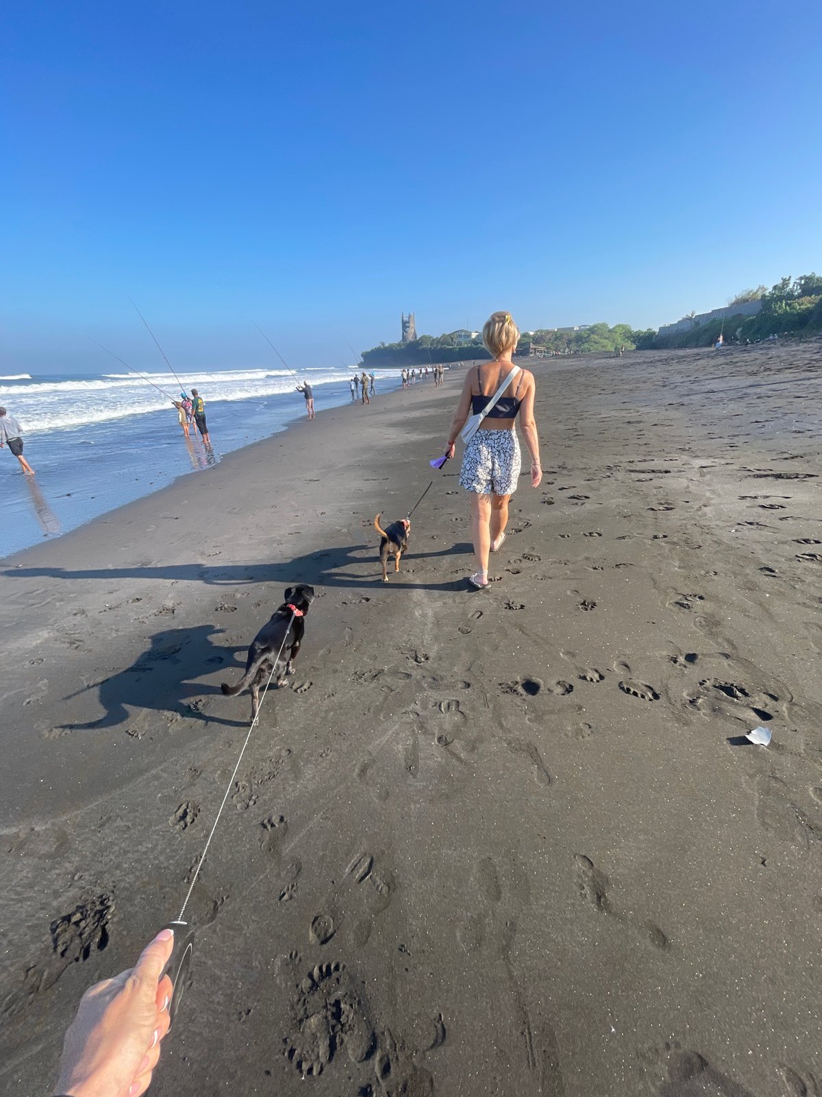 Fishing, dog walks, and selfies on a black sand beach