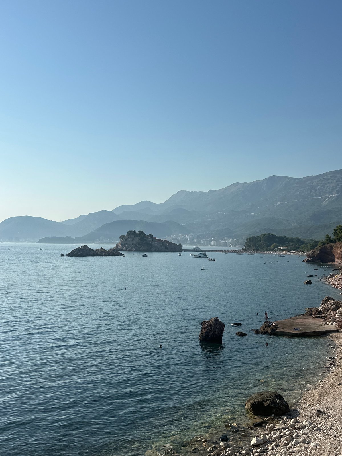Coastal afternoon in Sveti Stefan, ambulance incident on hillside road