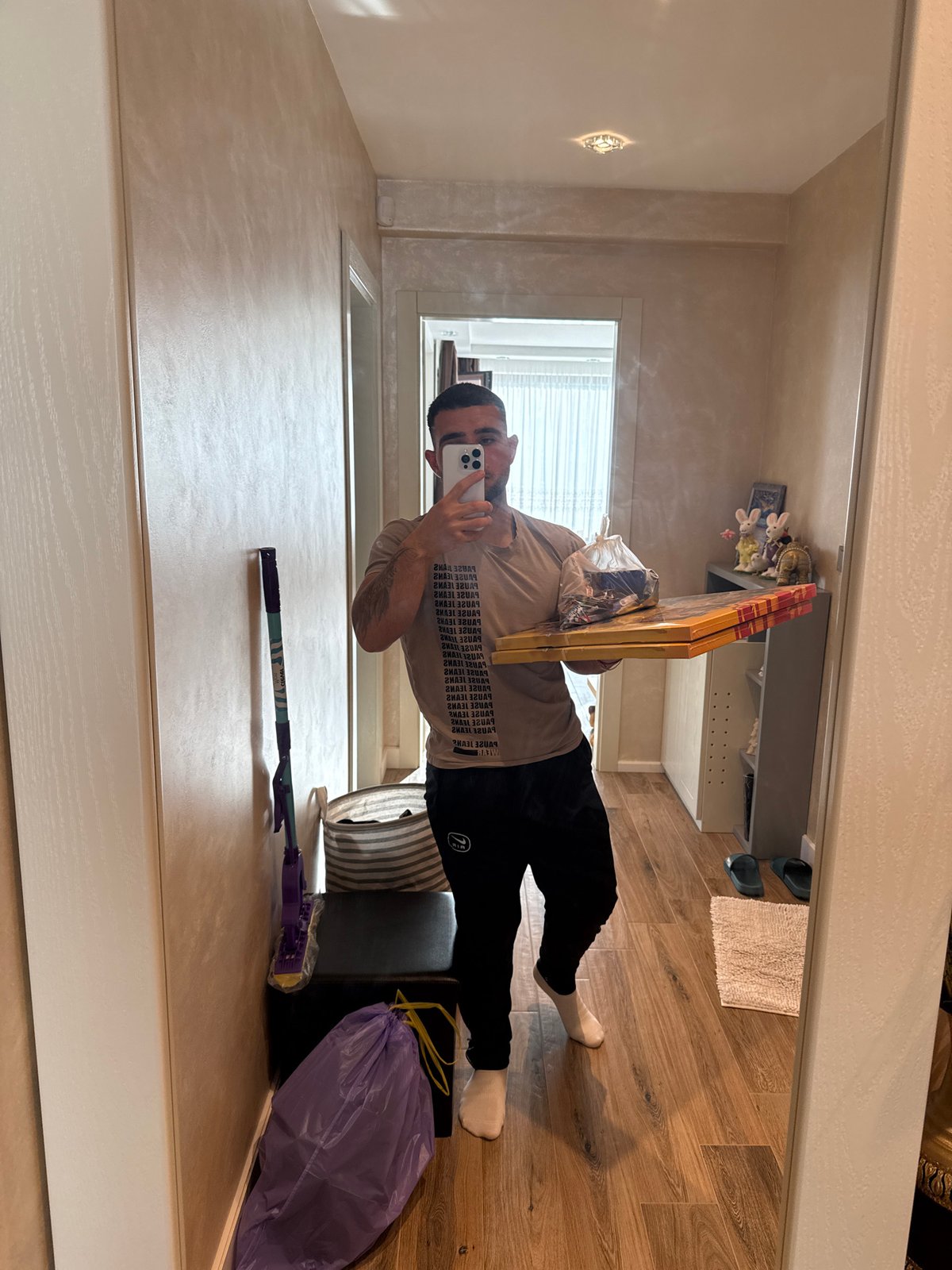 Artist displays wrapped canvases in mirror selfie, Gabrovo