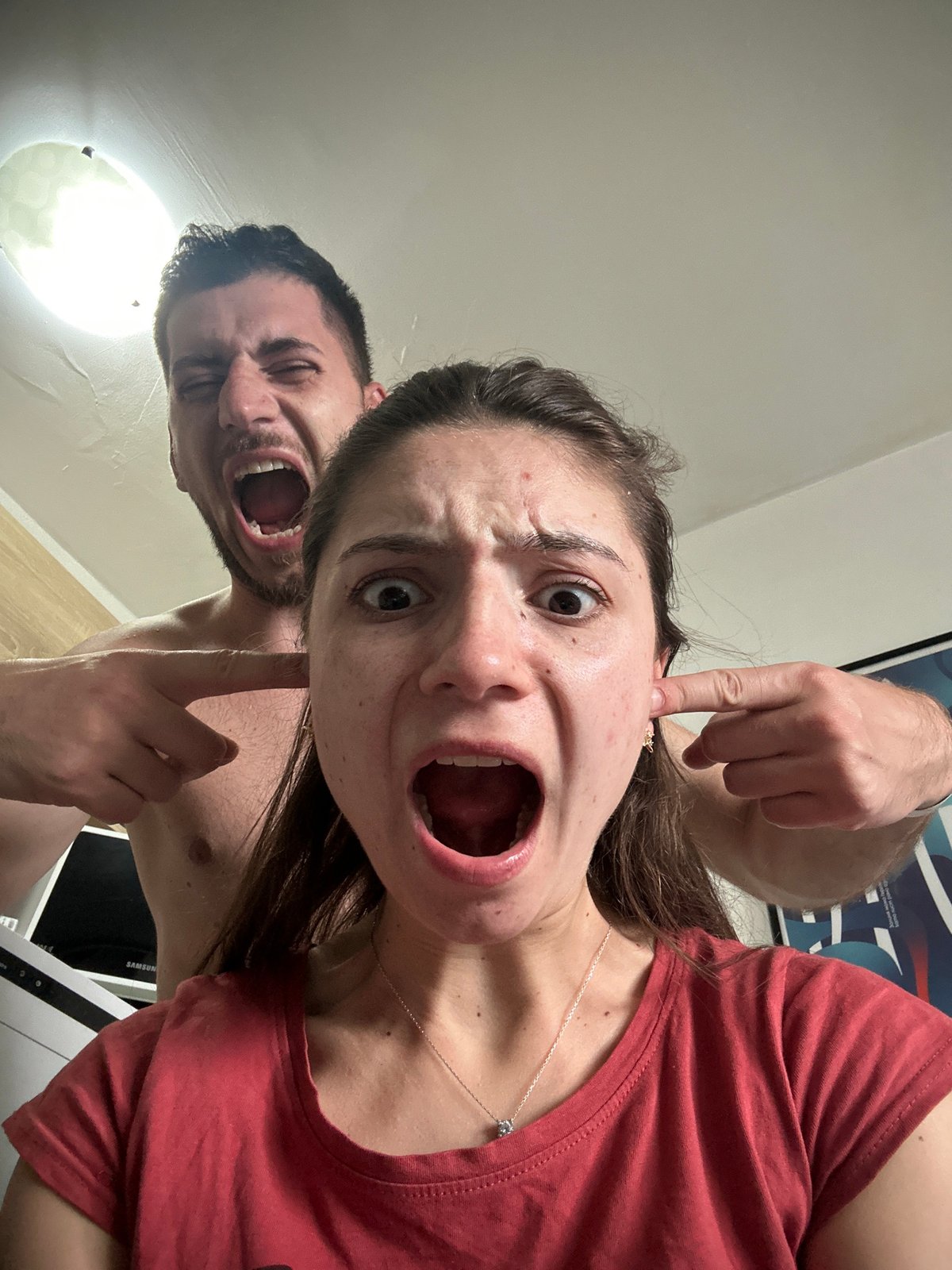 Couple photographed in playful domestic moments throughout Sofia apartment