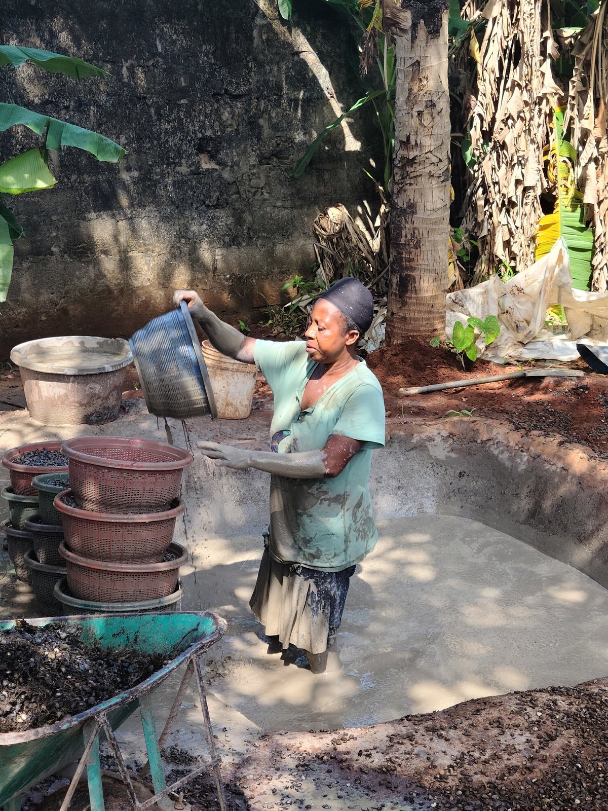 Manual processing work underway at outdoor site in Nnewi