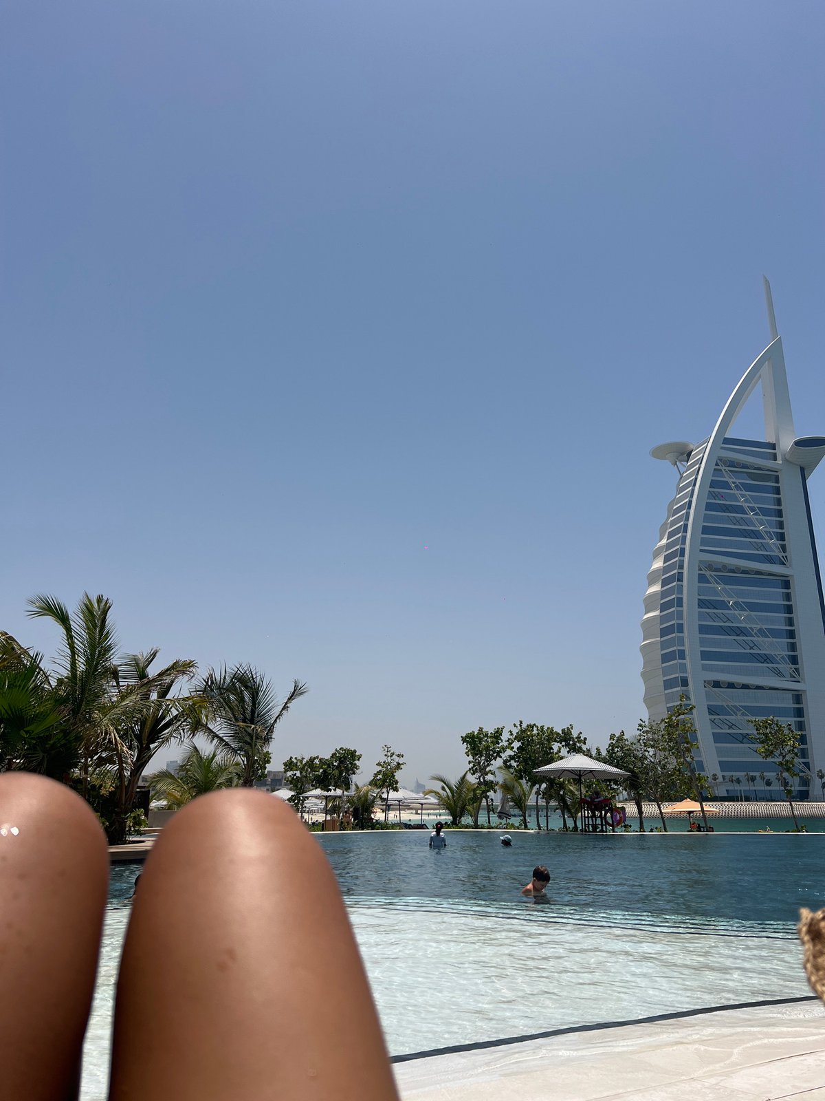 Morning swim captured at Dubai pool with Burj Al Arab backdrop
