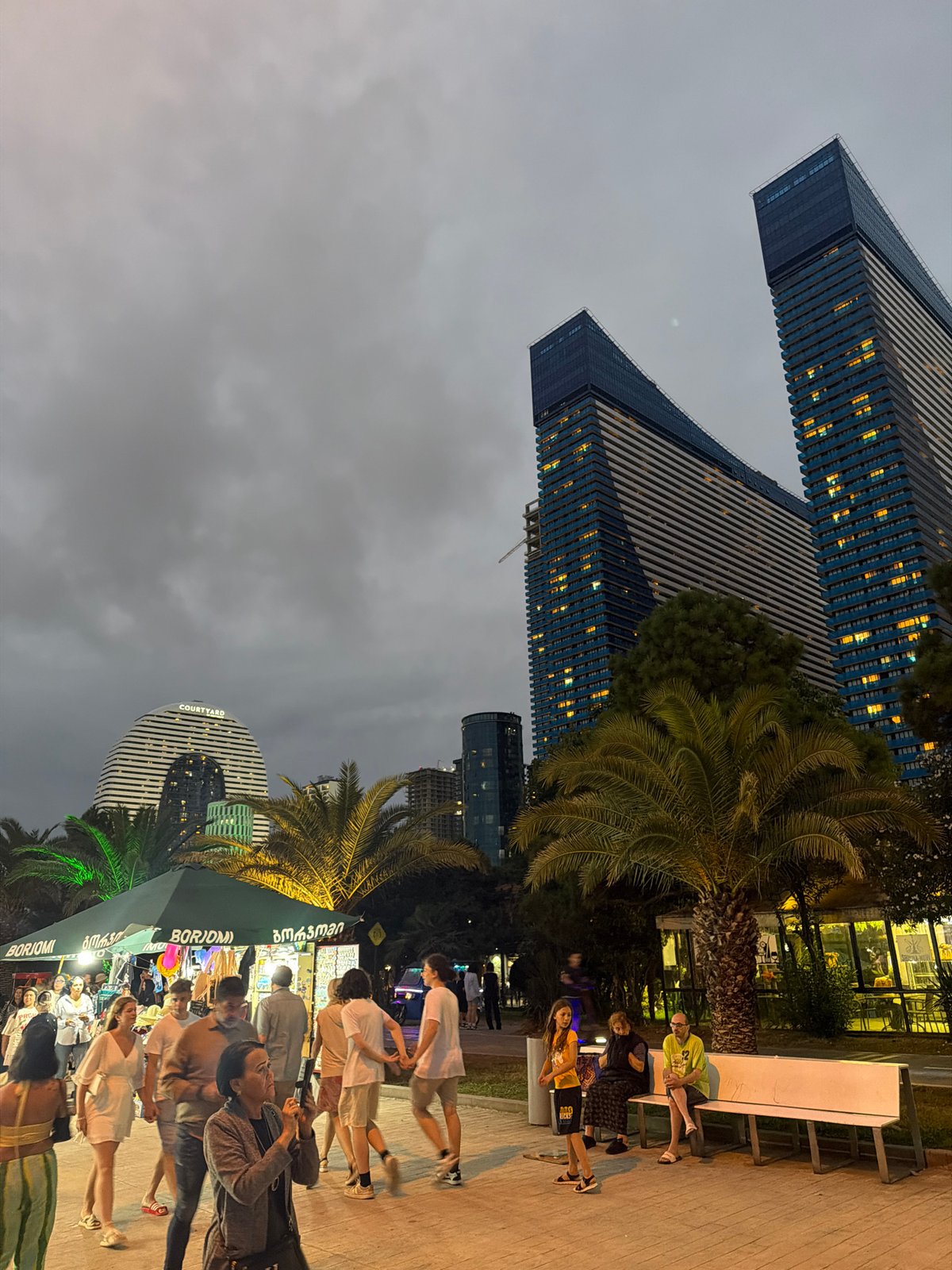 Batumi waterfront at dusk, skyscrapers and promenade in motion