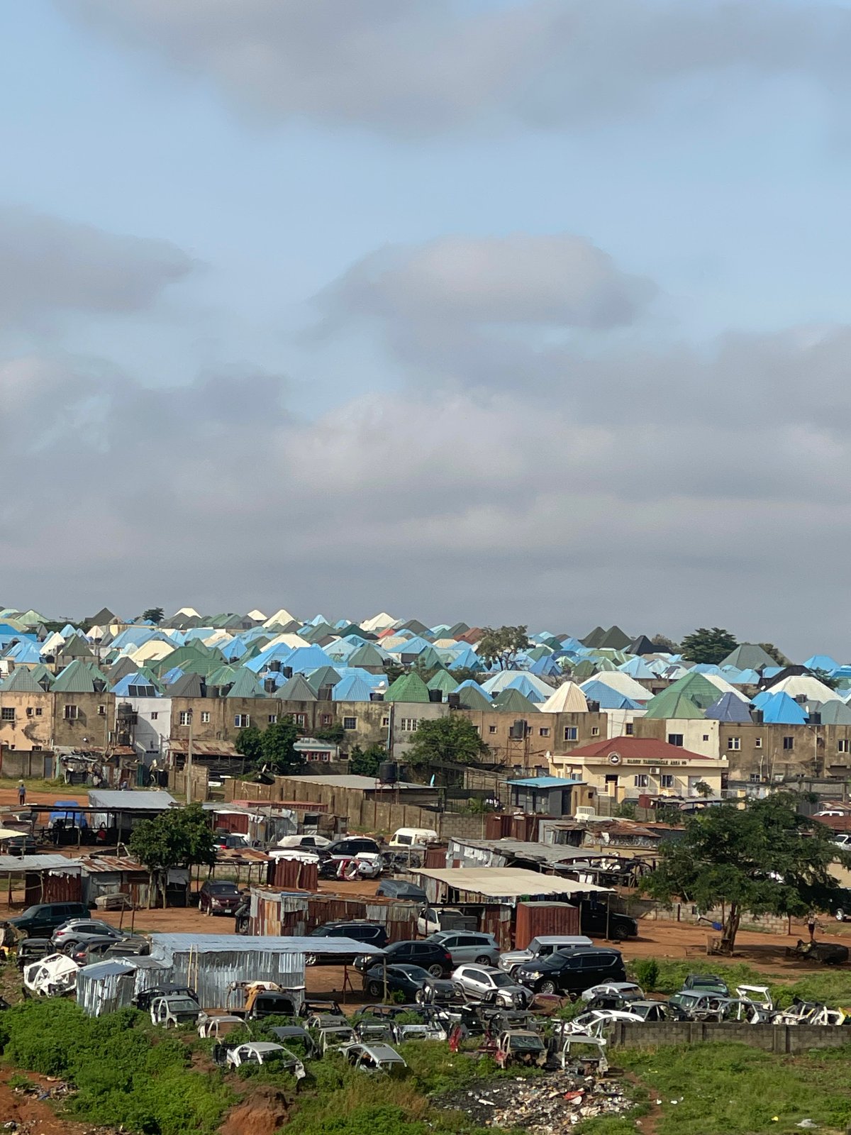 Abuja morning: city rooftops, modern homes, and street-level details