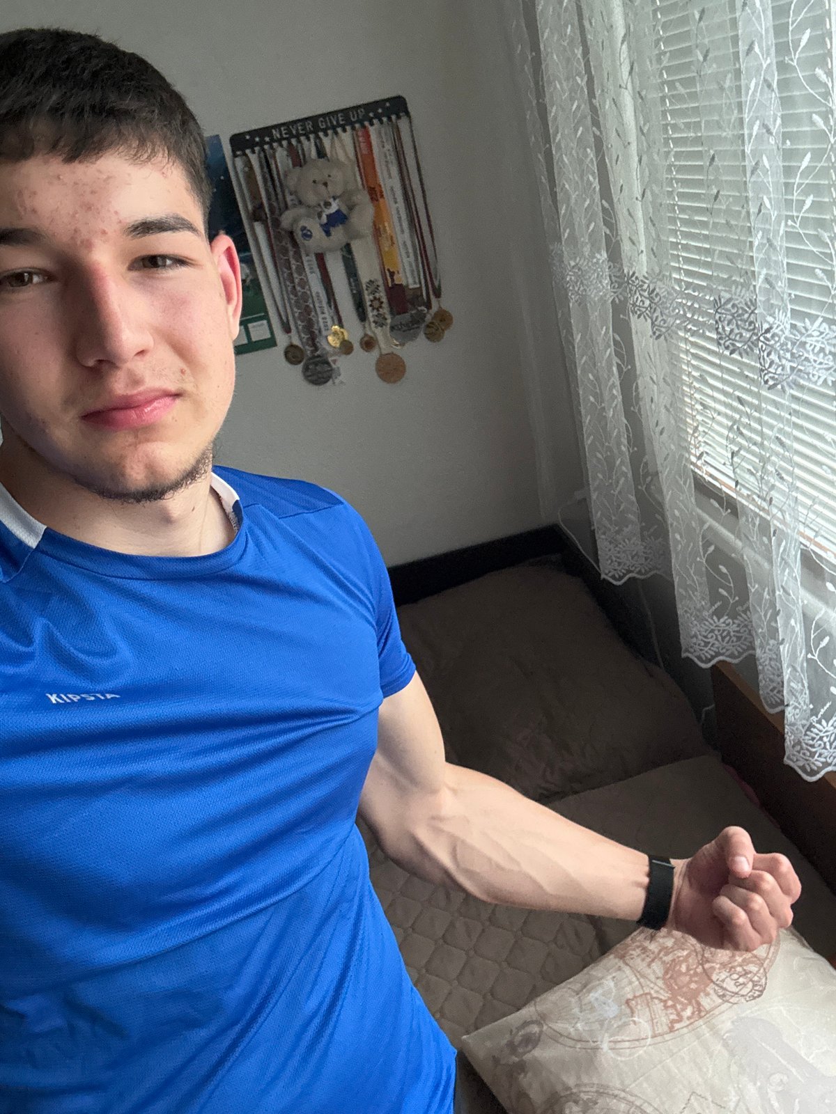 Young man takes selfies in bedroom in Zlatograd