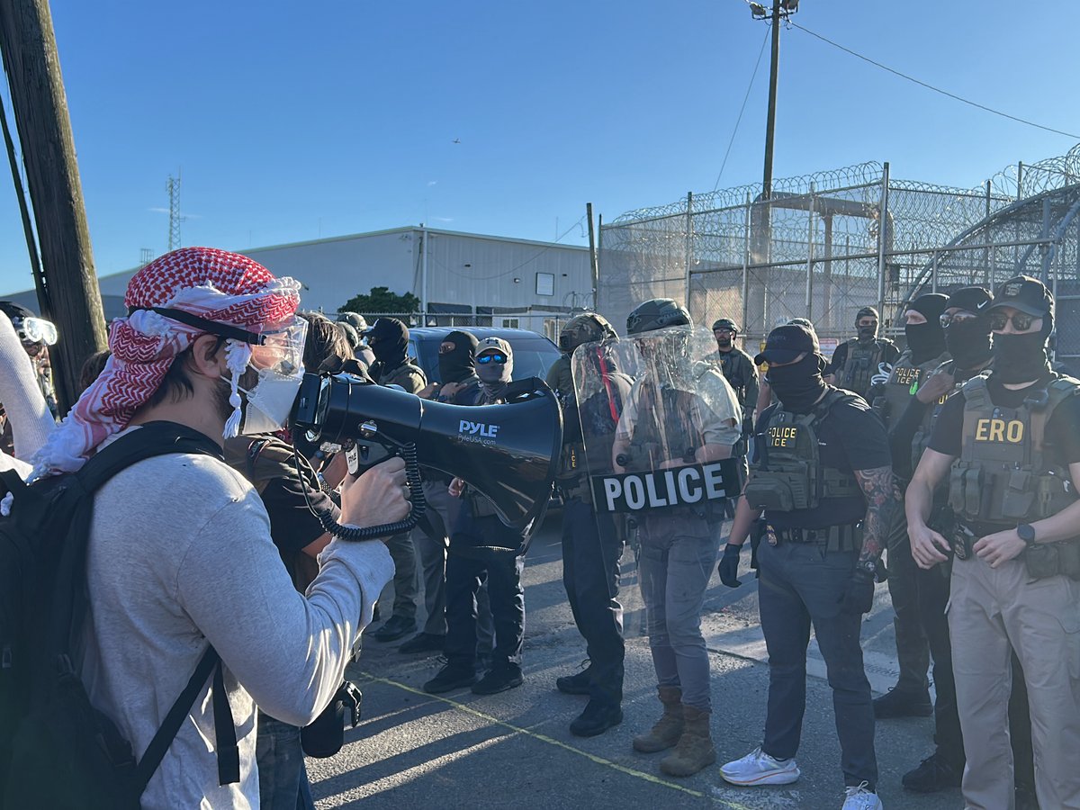 Protesters demonstrate outside Newark detention facility facing police line