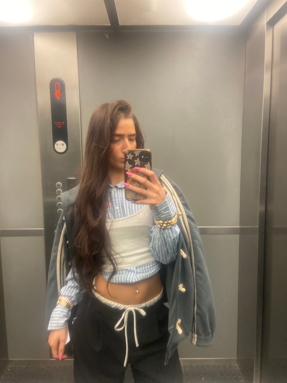 Woman takes selfies in London elevator