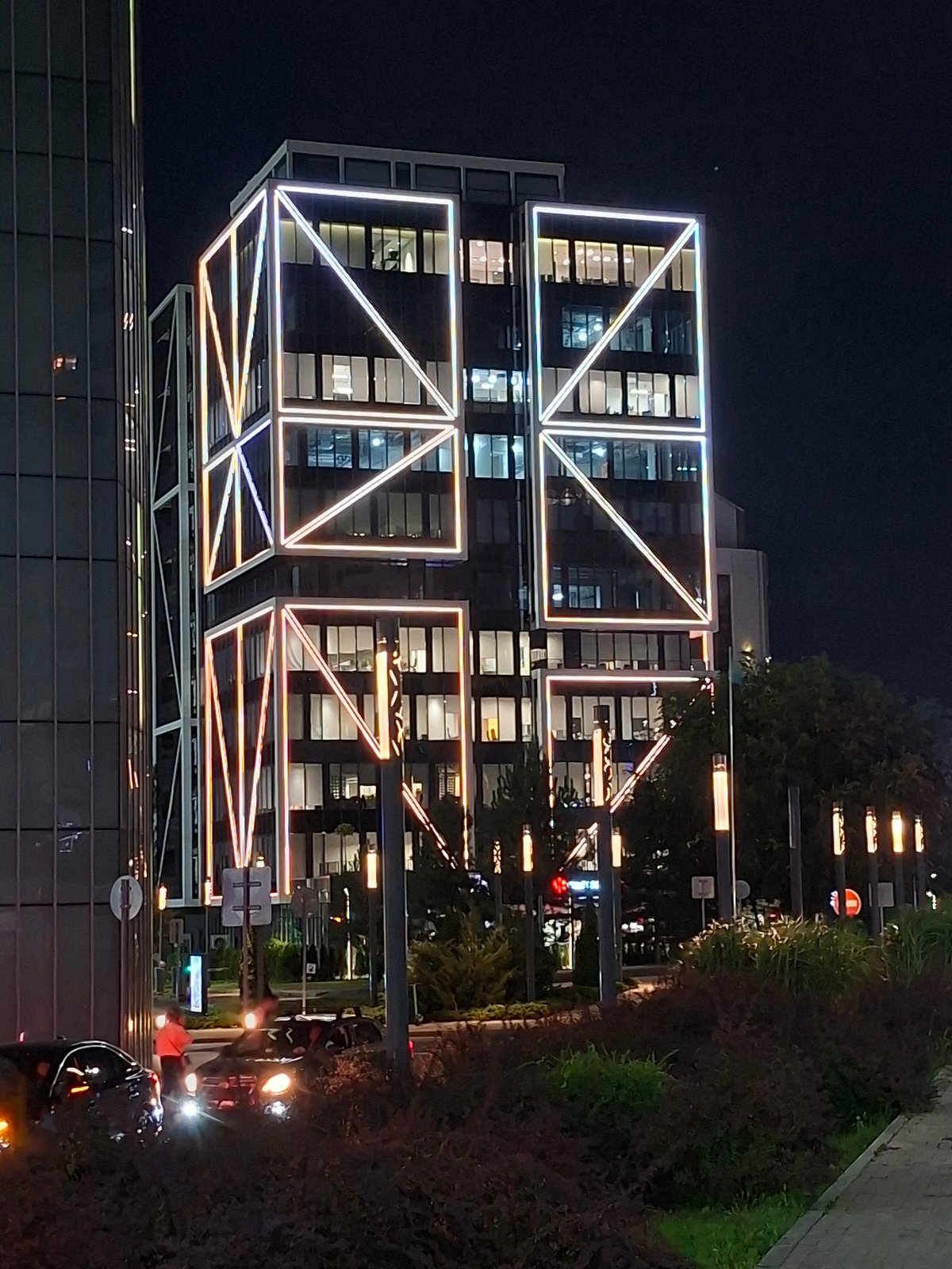 Almaty building glows at night with geometric neon lighting