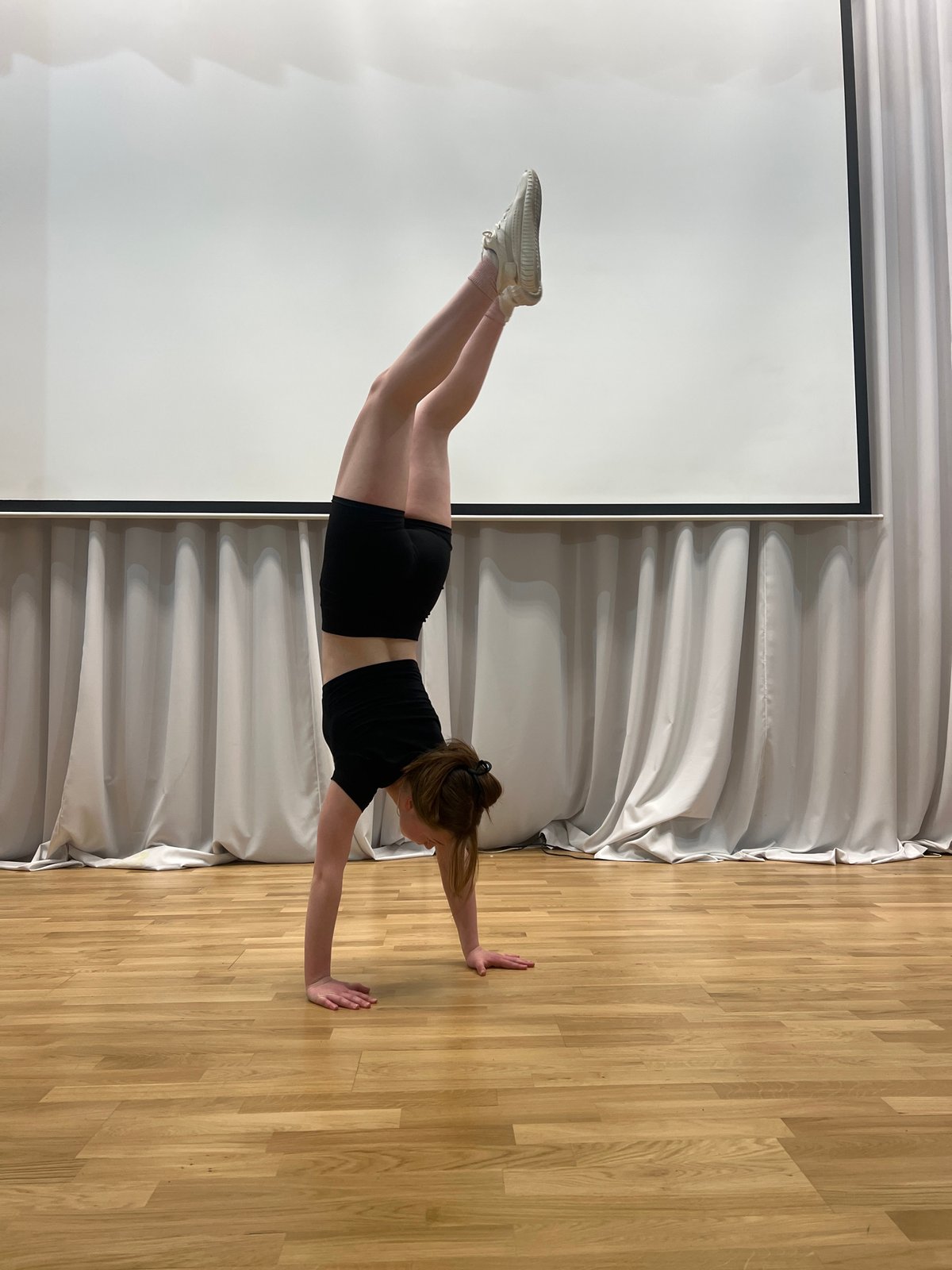 Woman performs wall plank exercise in Chaikovsky, Russia