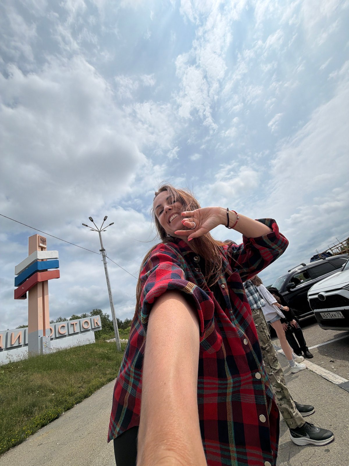 Selfie stop at the Moscow–Vladivostok road marker in Nikolaevka